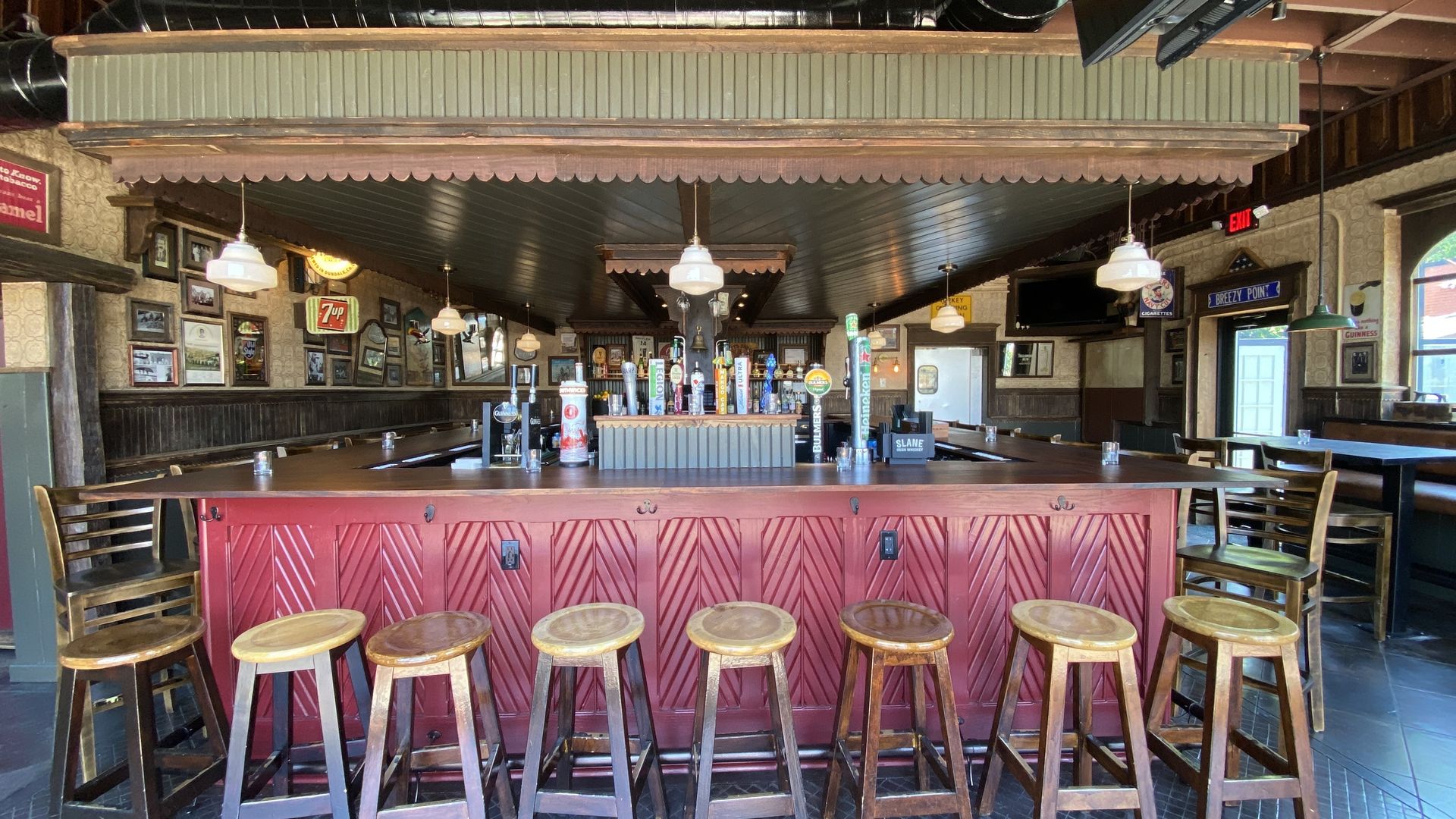 A bar with stools in front of it.