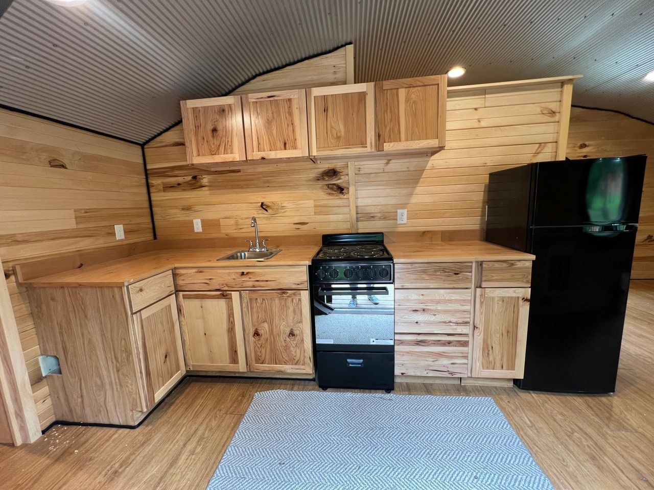 A kitchen with wood cabinets.