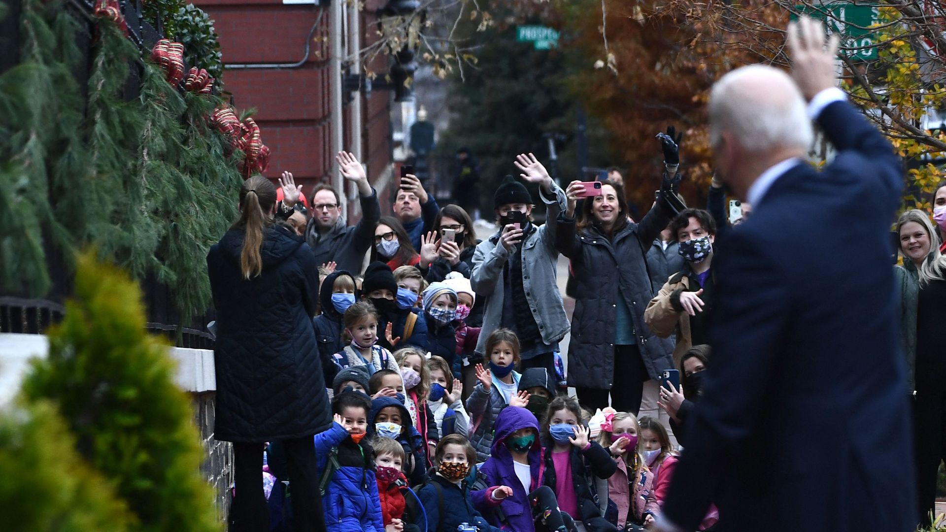 President Biden is seen waving to a group of children and their caretakers as he arrives at a Washington church.