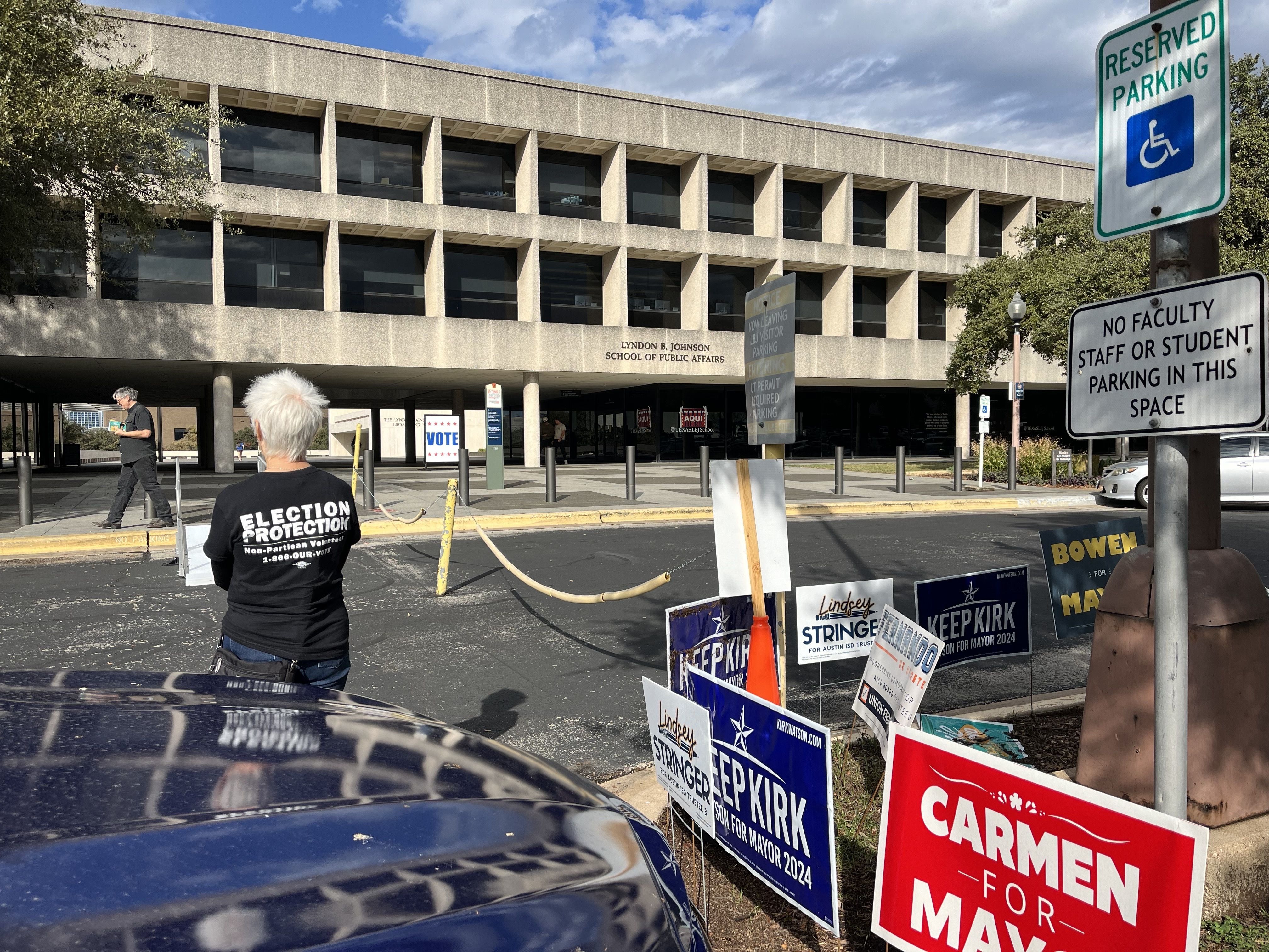 person stands outside polling place
