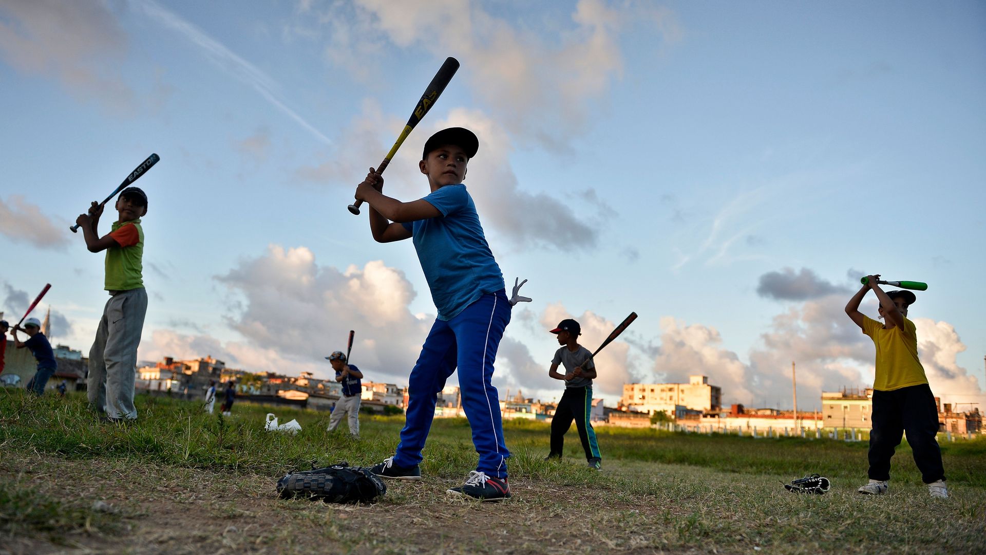 Cuban children practice baseball in a field of Havana, on September 17, 2018