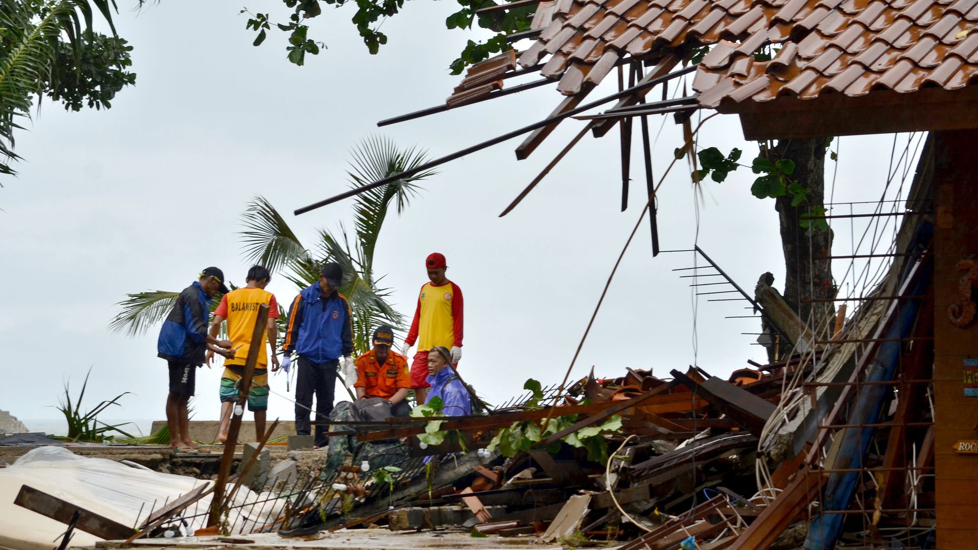People in indonesia assessing damage from tsunami