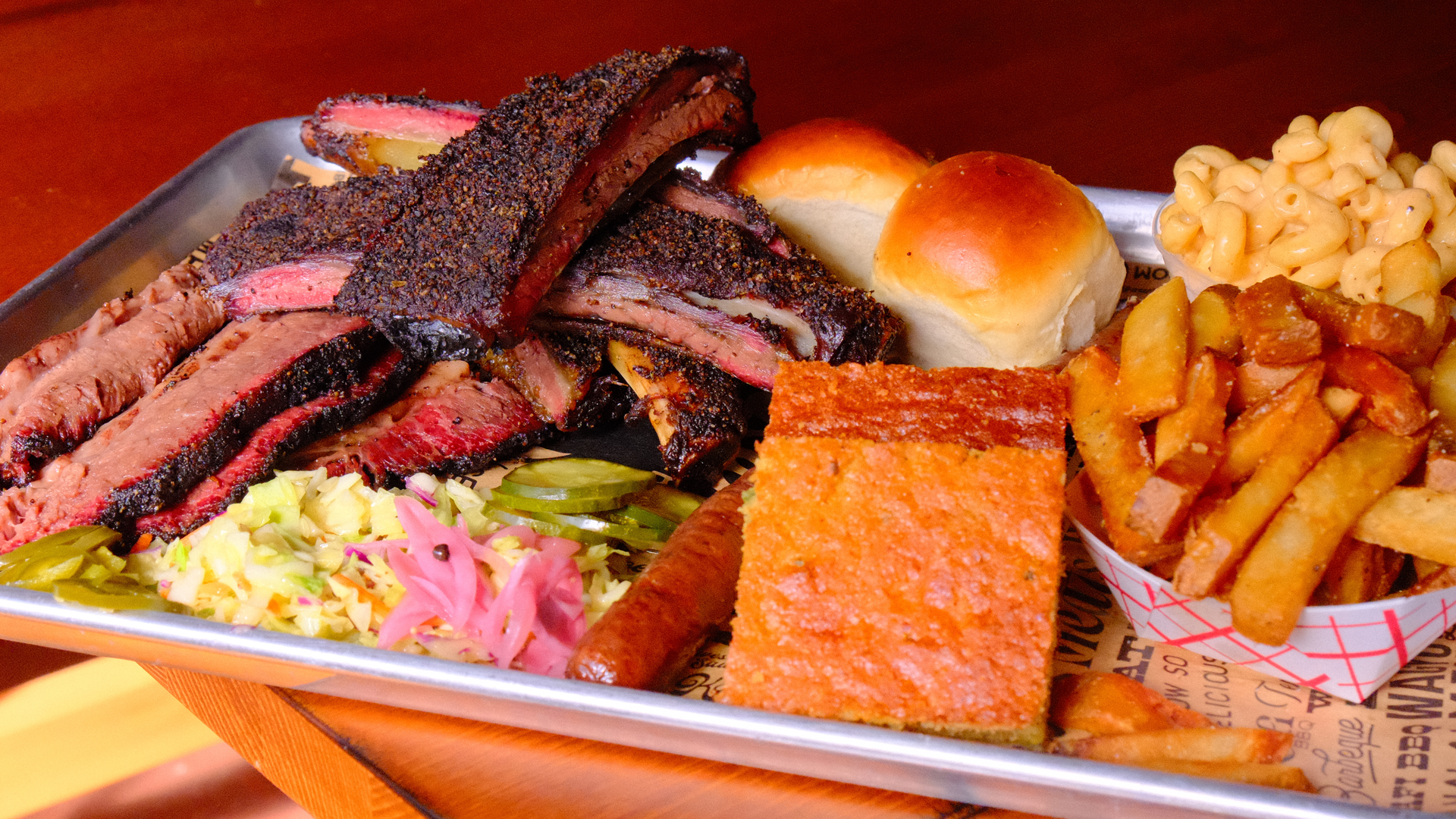 A close-up photo of a barbecue platter with brisket and sides