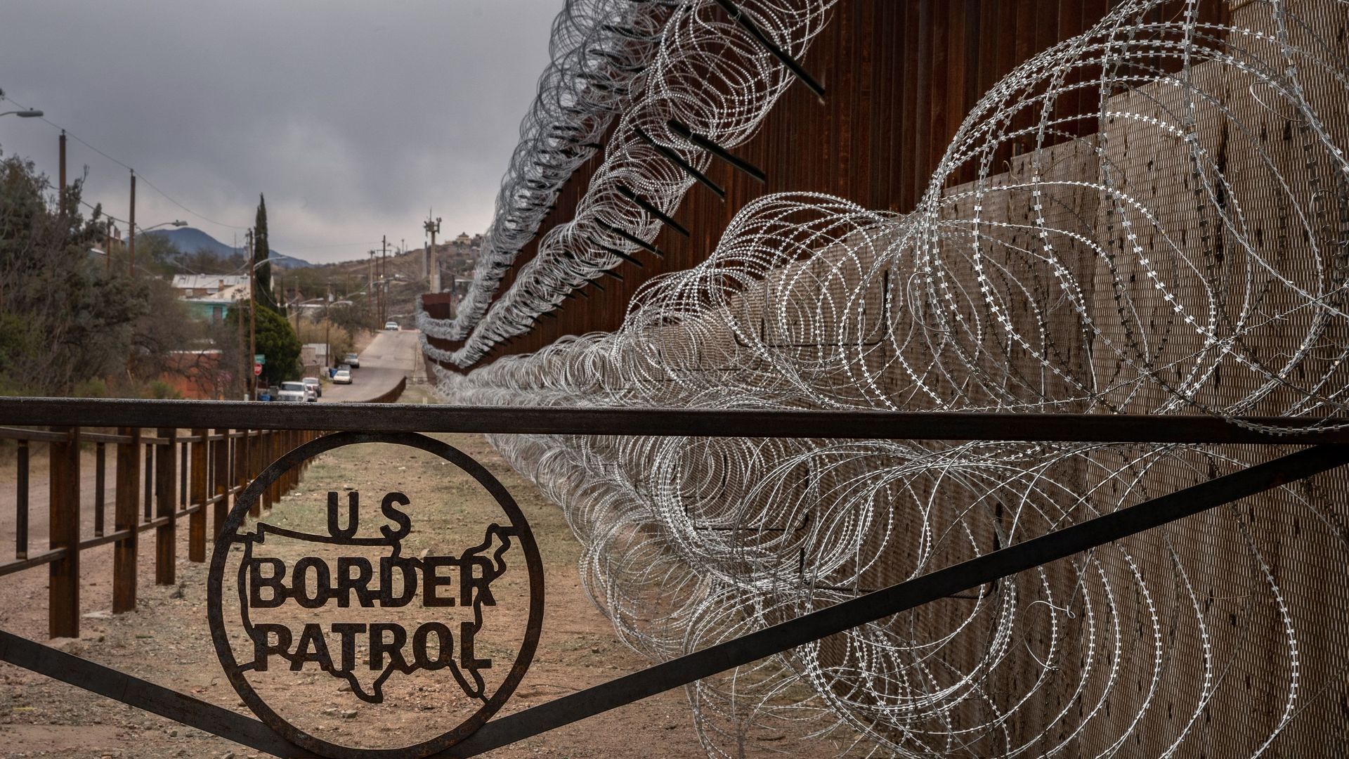 A metal fence marked with the US Border Patrol sign prevents people to get close to the barbed/concertina wire covering the US/Mexico border fence, in Nogales, Arizona, on February 9, 2019.