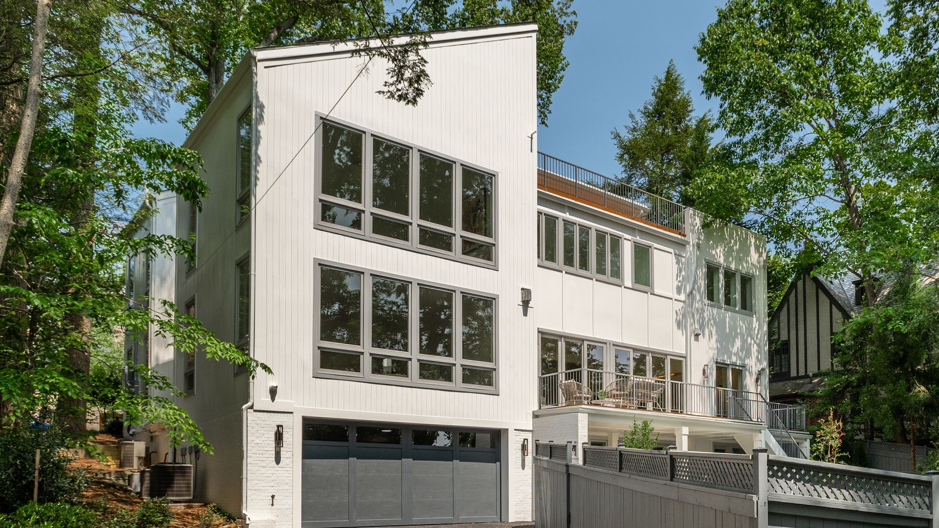 The exterior facade view of a white, contemporary-style home.