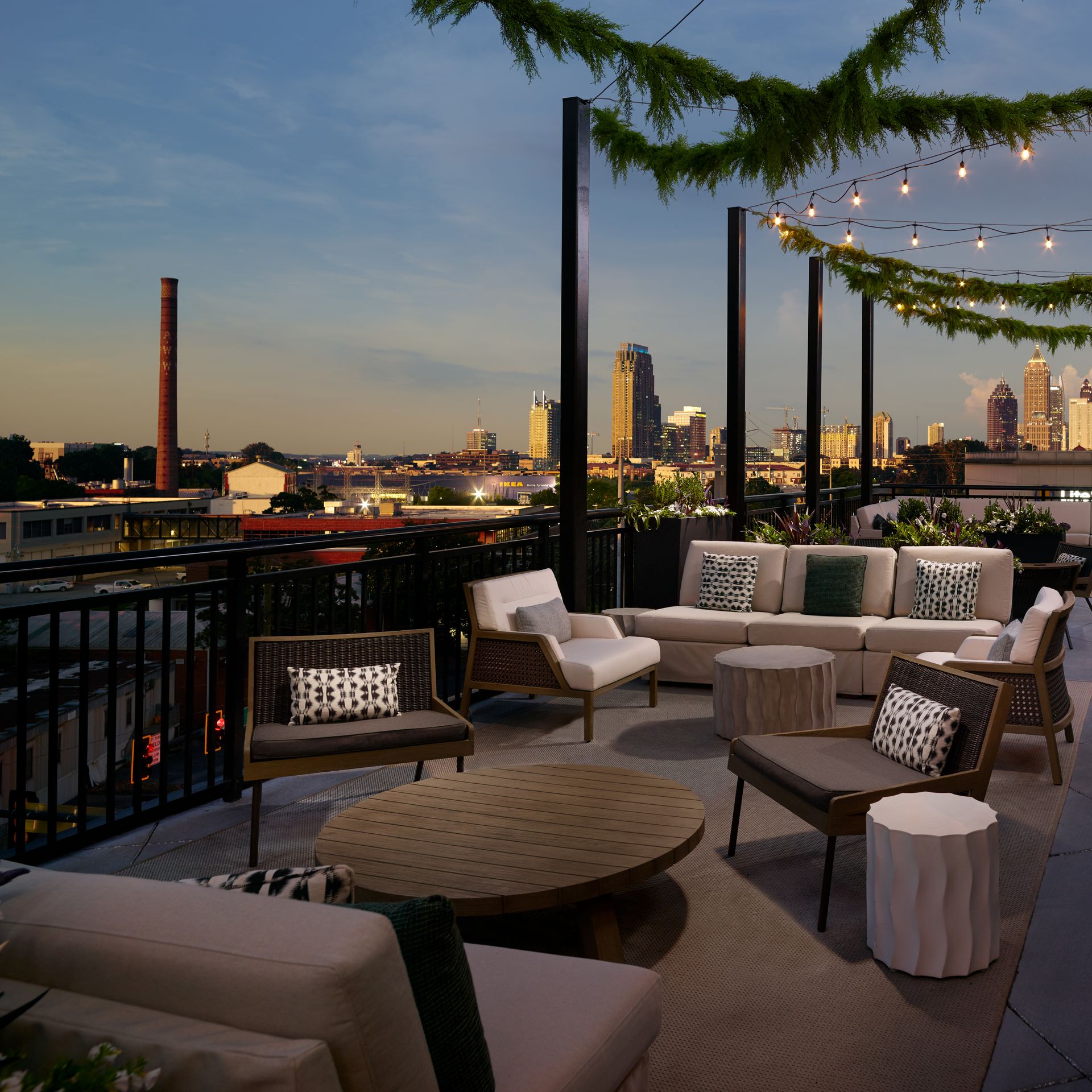 A rooftop terrace at night in front of Atlanta skyline