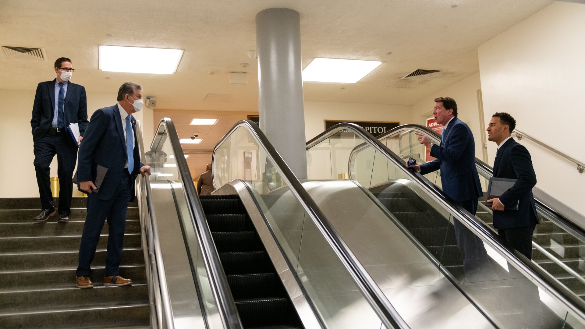 Sen. Bill Hagerty is seen speaking with Sen. Joe Manchin across the Capitol escalators.