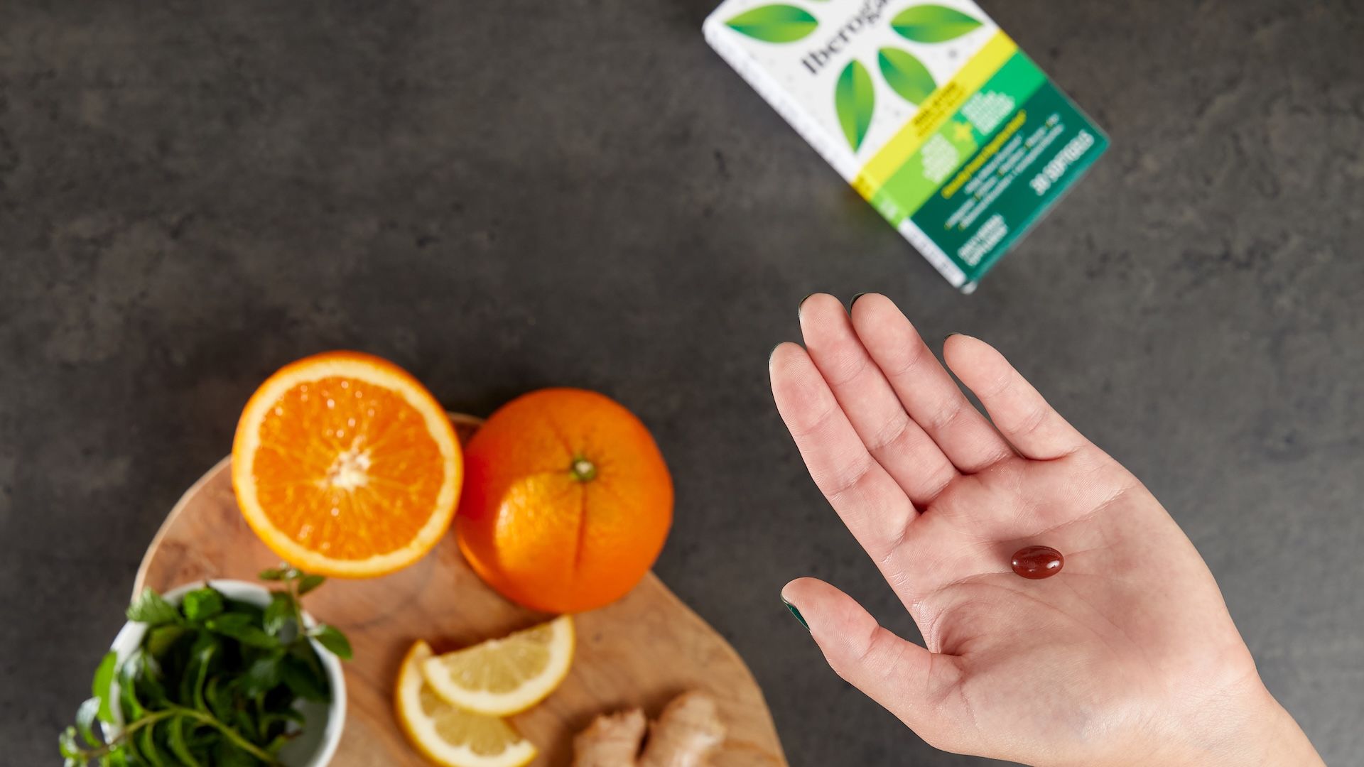A hand holding a medicine pill.