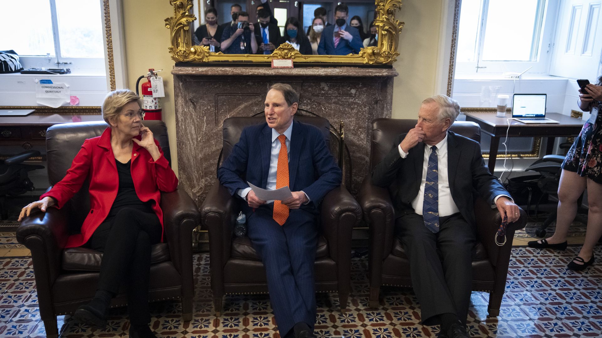 Sens. Elisabeth Warren, Ron Wyden and Angus King are seen speaking with reporters in the Senate Press Gallery.