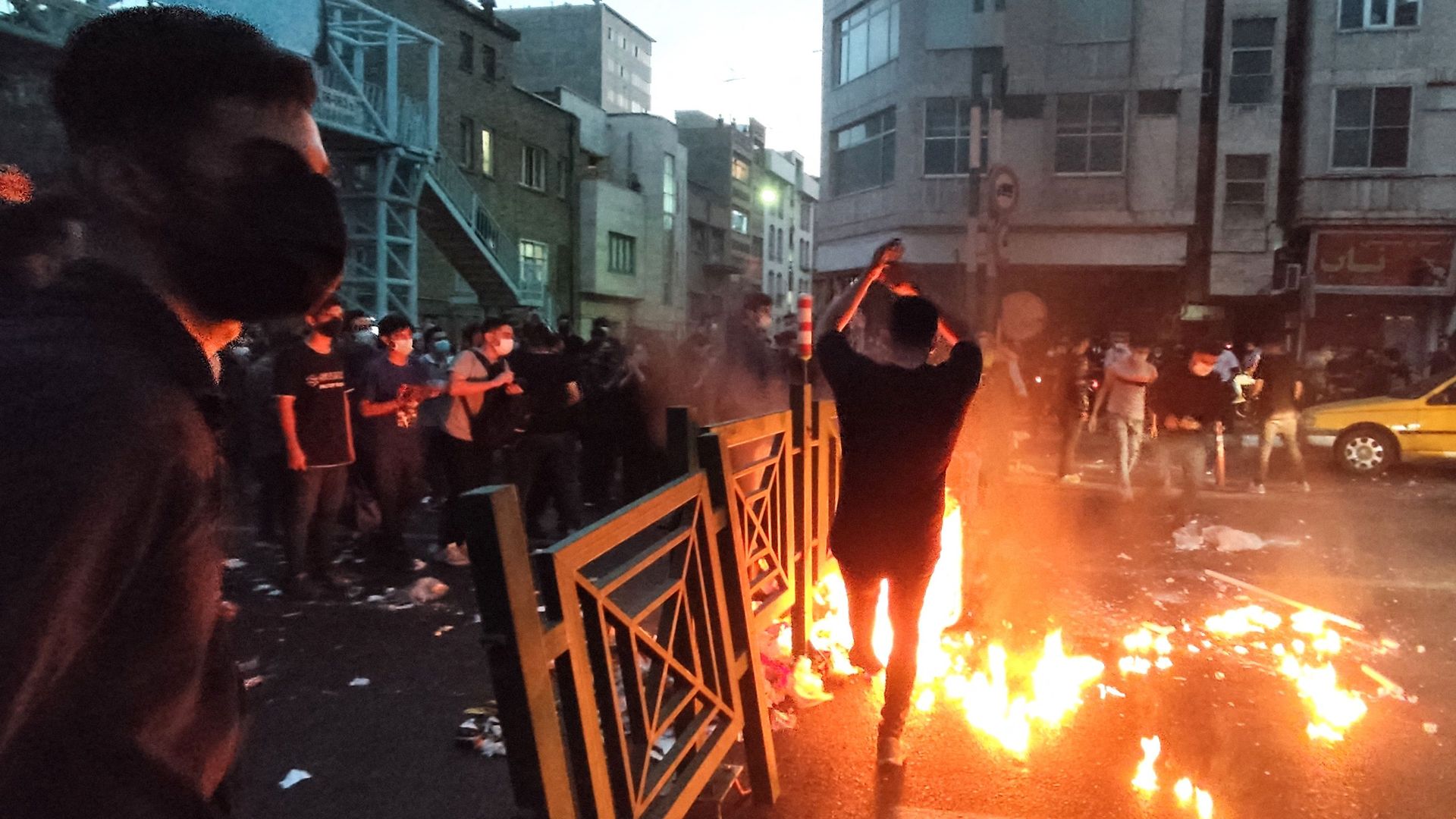 Demonstrators around a fire in Tehran on Sept. 21.