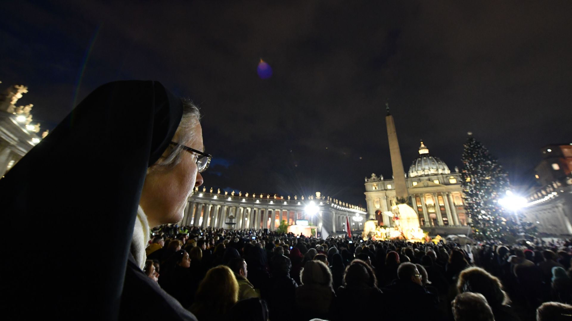 A nun in a crowd at the Vatican during Christmas.
