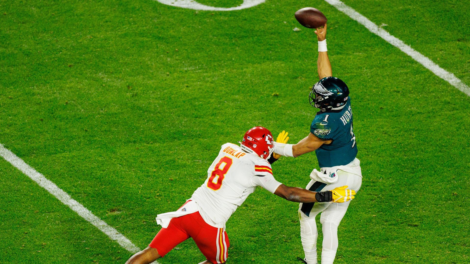 Philadelphia Eagles quarterback Jalen Hurts throws a pass under pressure.