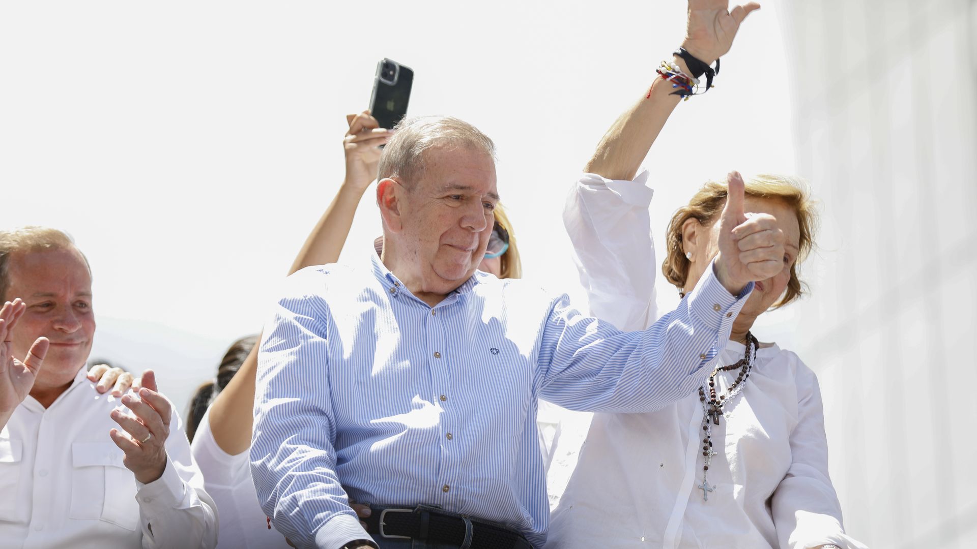 Edmundo González Urrutia gives a thumbs up while looking down at a crowd cheering for him in Caracas, Venezuela