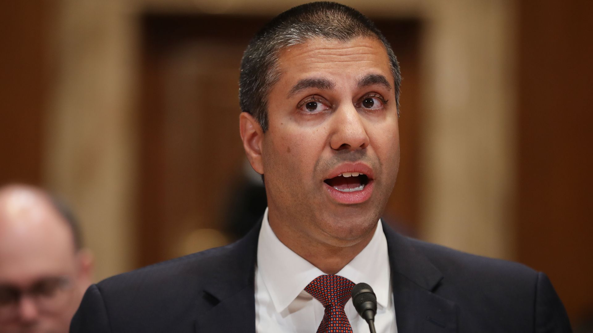 A photo of FCC Chairman Ajit Pai speaking into a microphone.