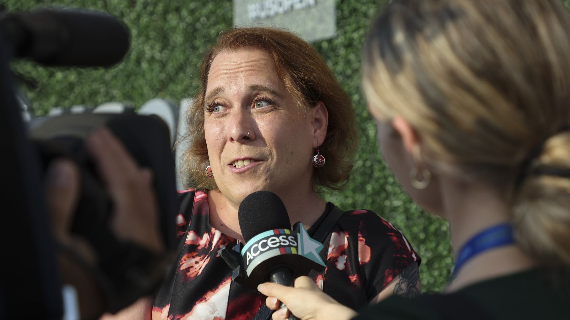 Photo of Amy Schneider speaking to media