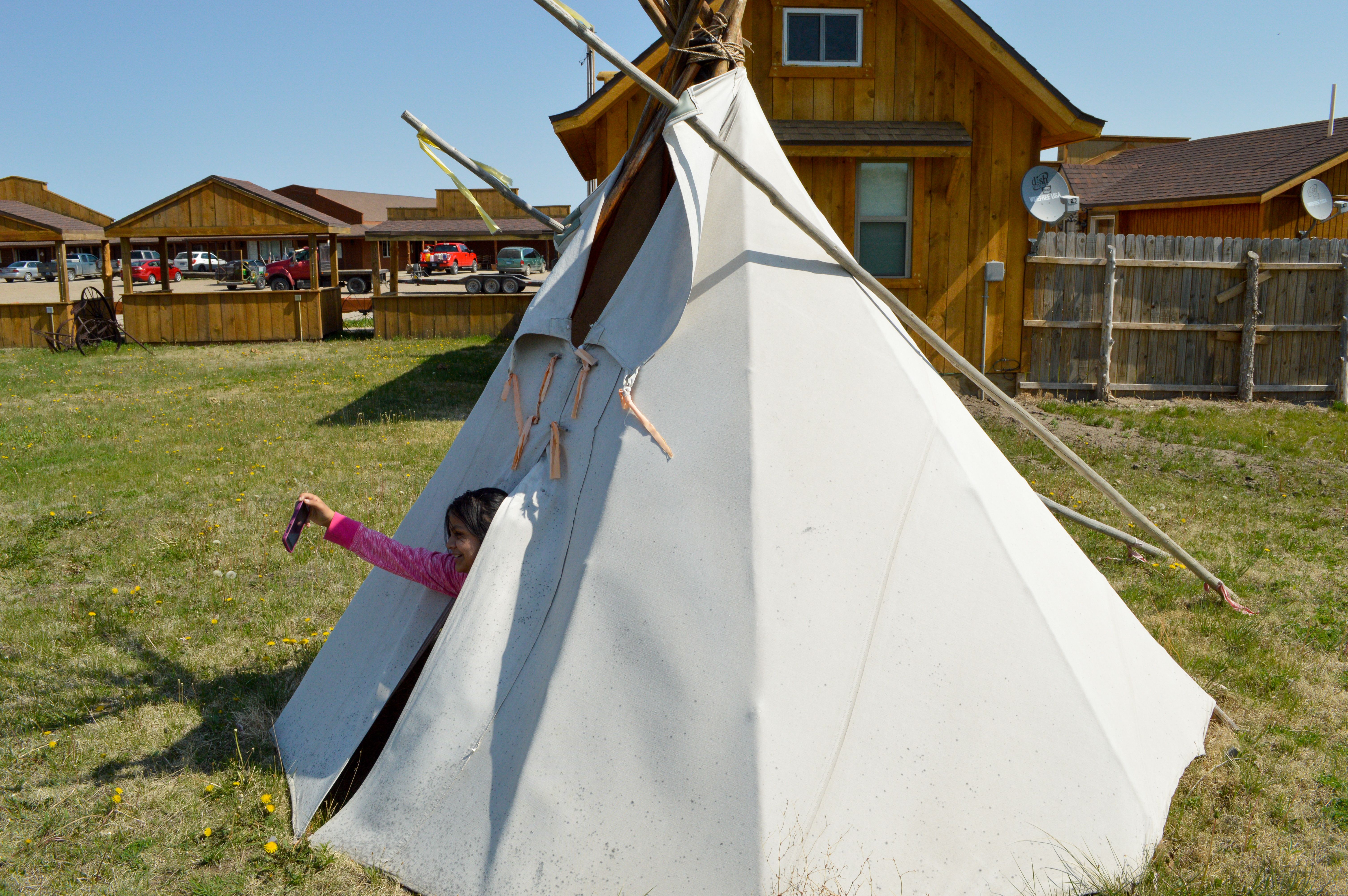 Maya Eagle, an Oglala Lakota girl, takes a selfie while inside a teepee on the Pine Ridge Indian Reservation in South Dakota, on May 1, 2015.