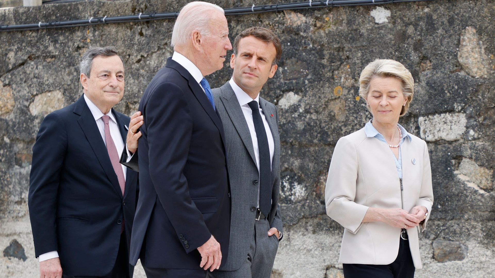 US President Joe Biden (L) and France's President Emmanuel Macron speak after the family photo at the start of the G7 summit in Carbis Bay, Cornwall on June 11, 2021.
