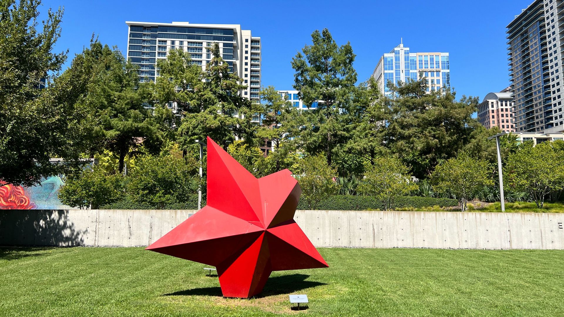 A photo of a lawn with a red star sculpture