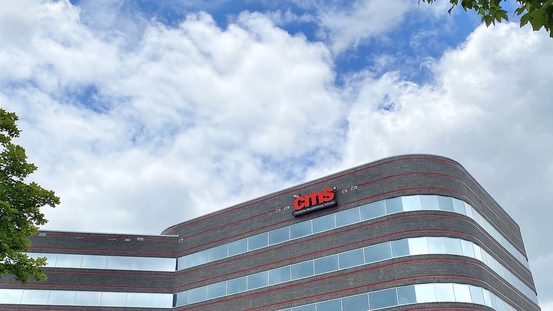 multistory building with windows and a CMS logo
