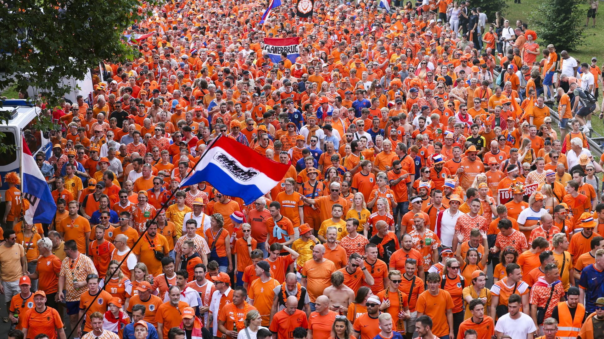10 July 2024, North Rhine-Westphalia, Dortmund: Soccer: European Championship, Netherlands - England, final round, semi-final. Dutch fans celebrate before the game at the fan walk to the stadium. 