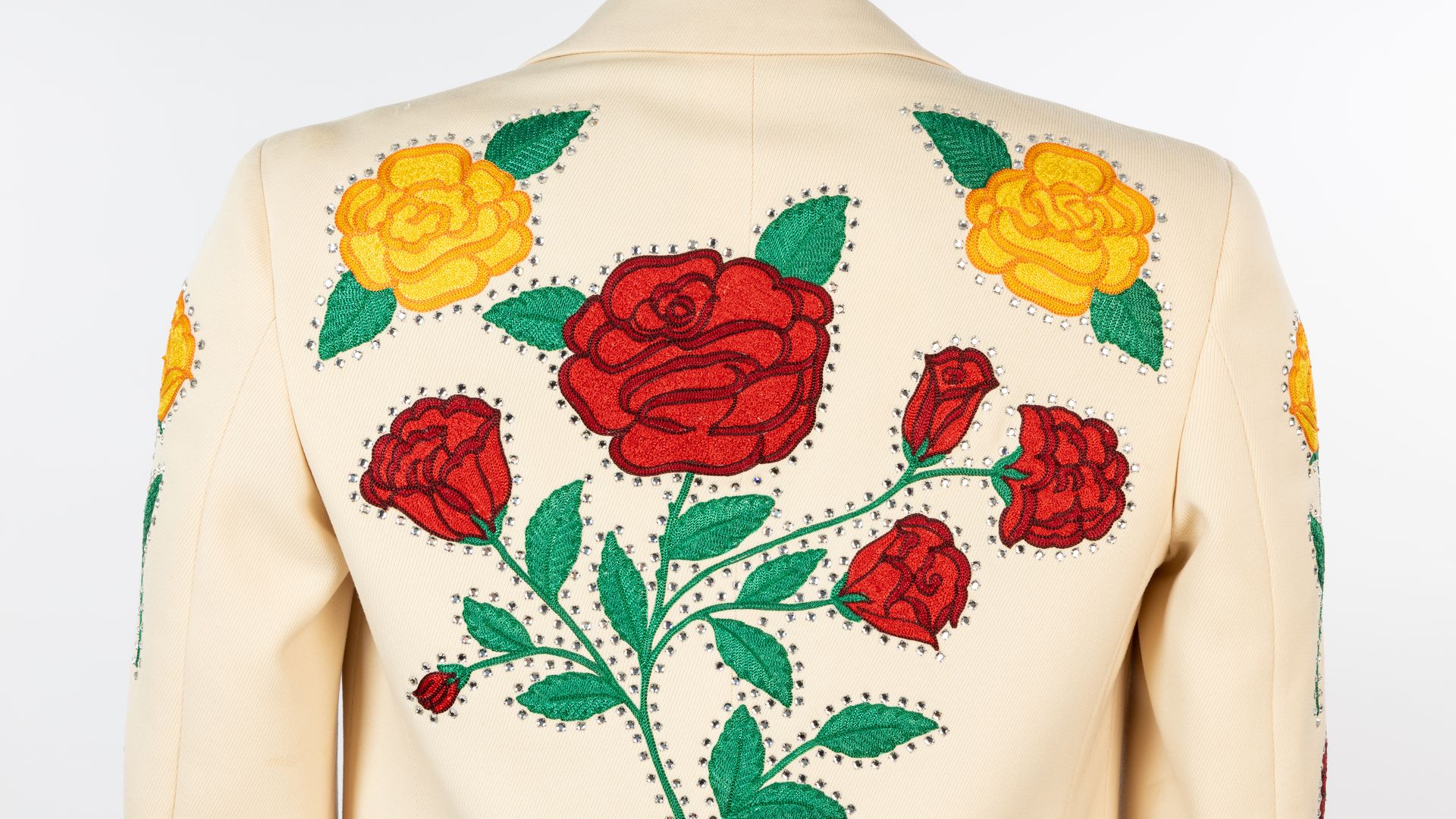 A suit with roses on the back.