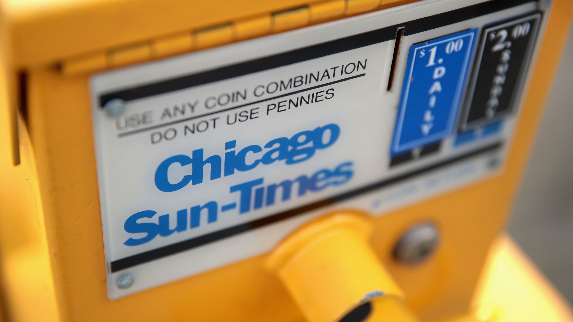 Photo of a newspaper box that says "Chicago Sun-Times" 
