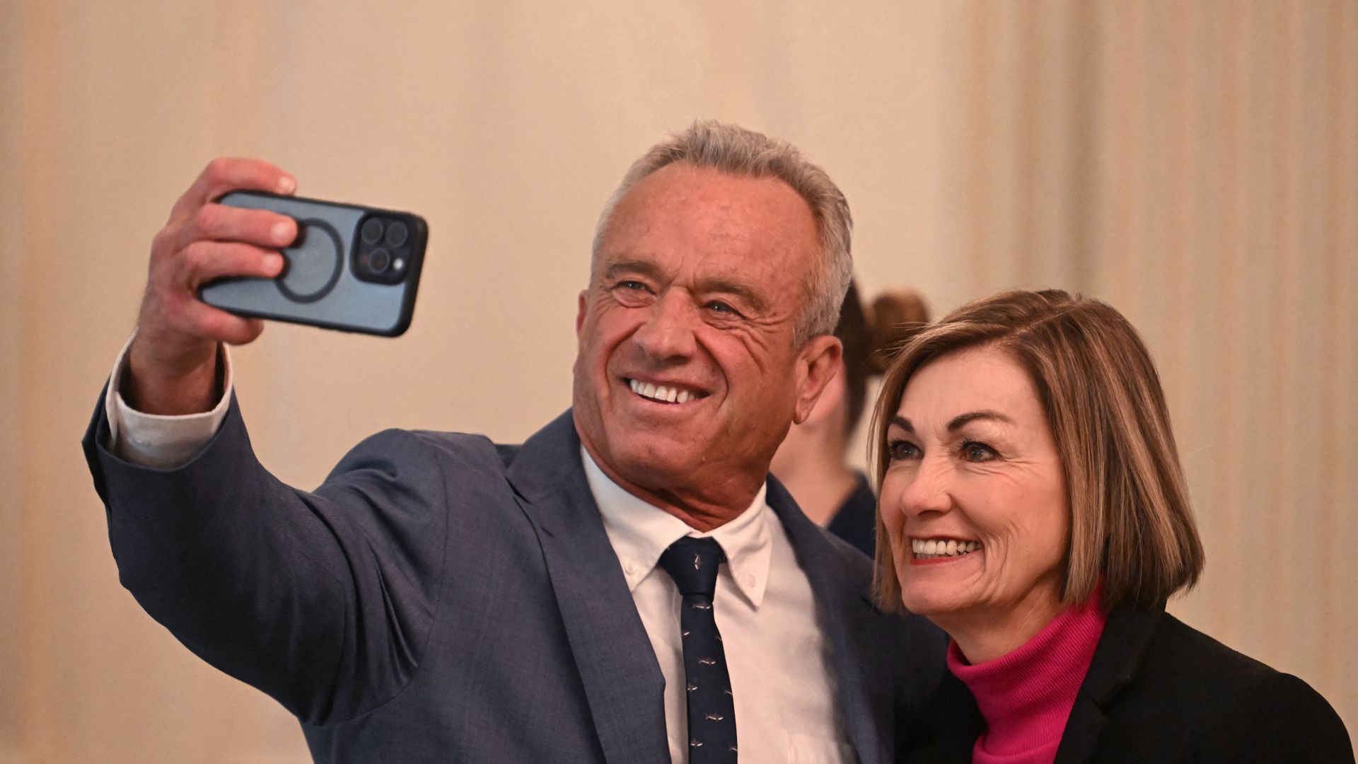 US HHS Secretary Robert F. Kennedy Jr. (L) takes photo with Iowa Governor Kim Reynolds, as they attend the Governors Working Session in February.