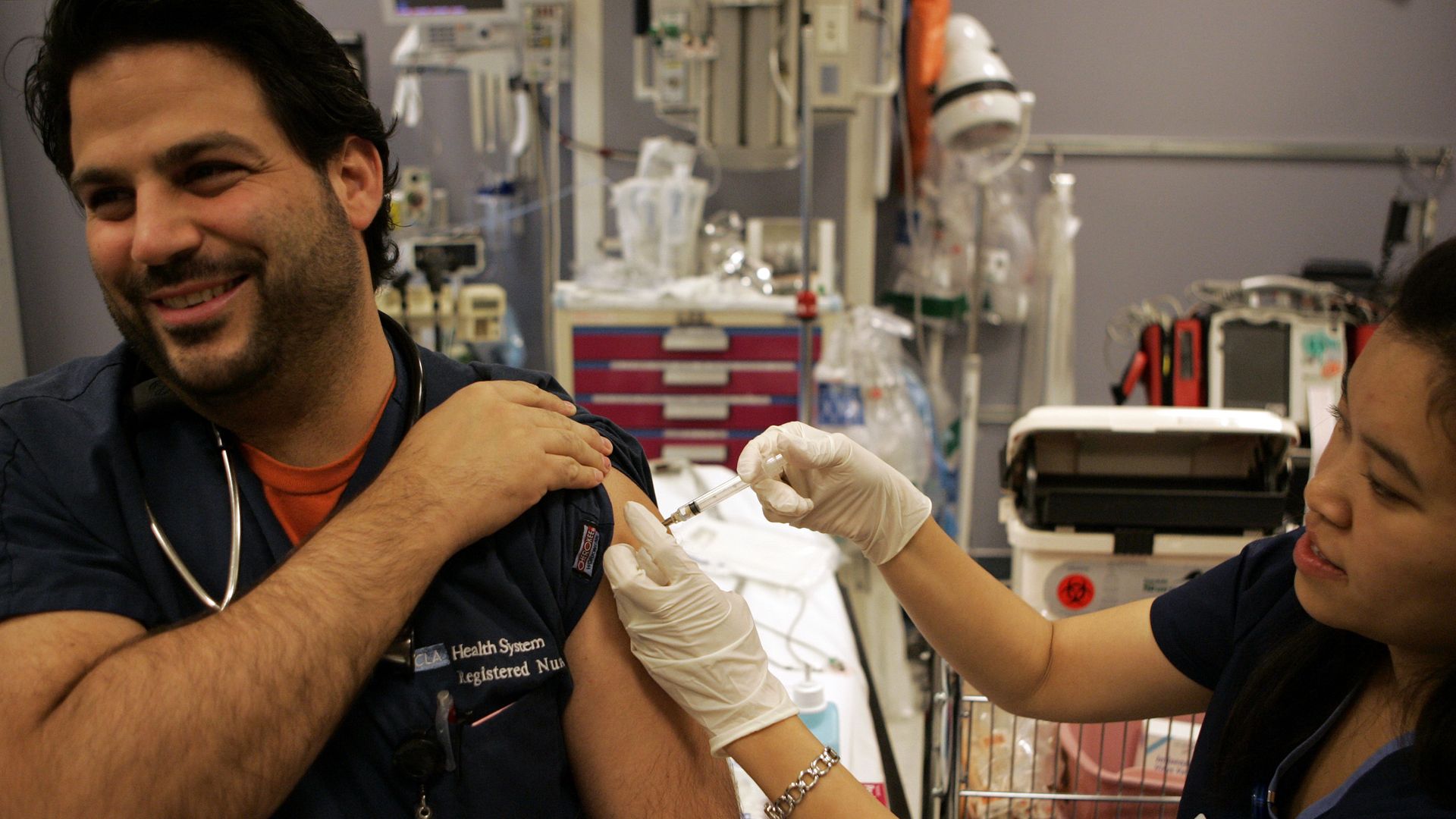 A nurse gets the flu vaccine
