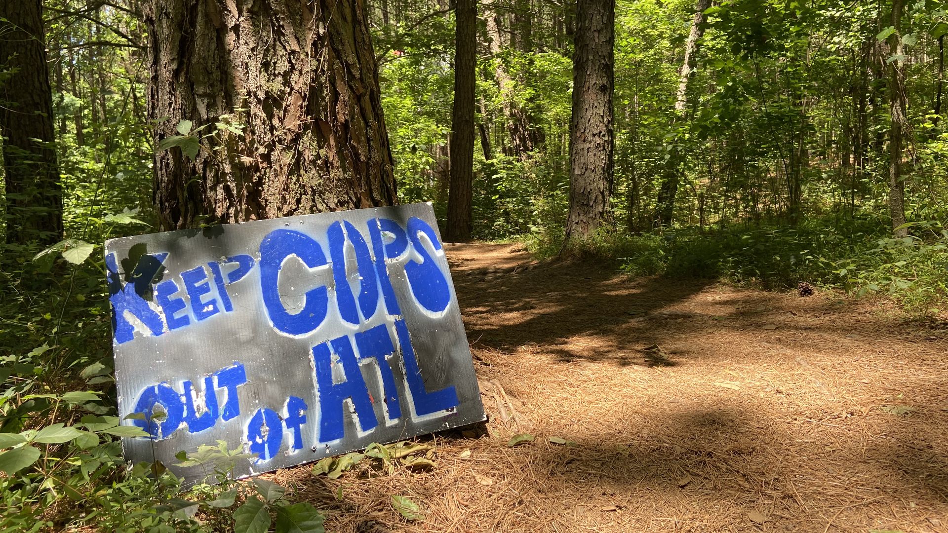 A sign in the woods that says no cops in ATL