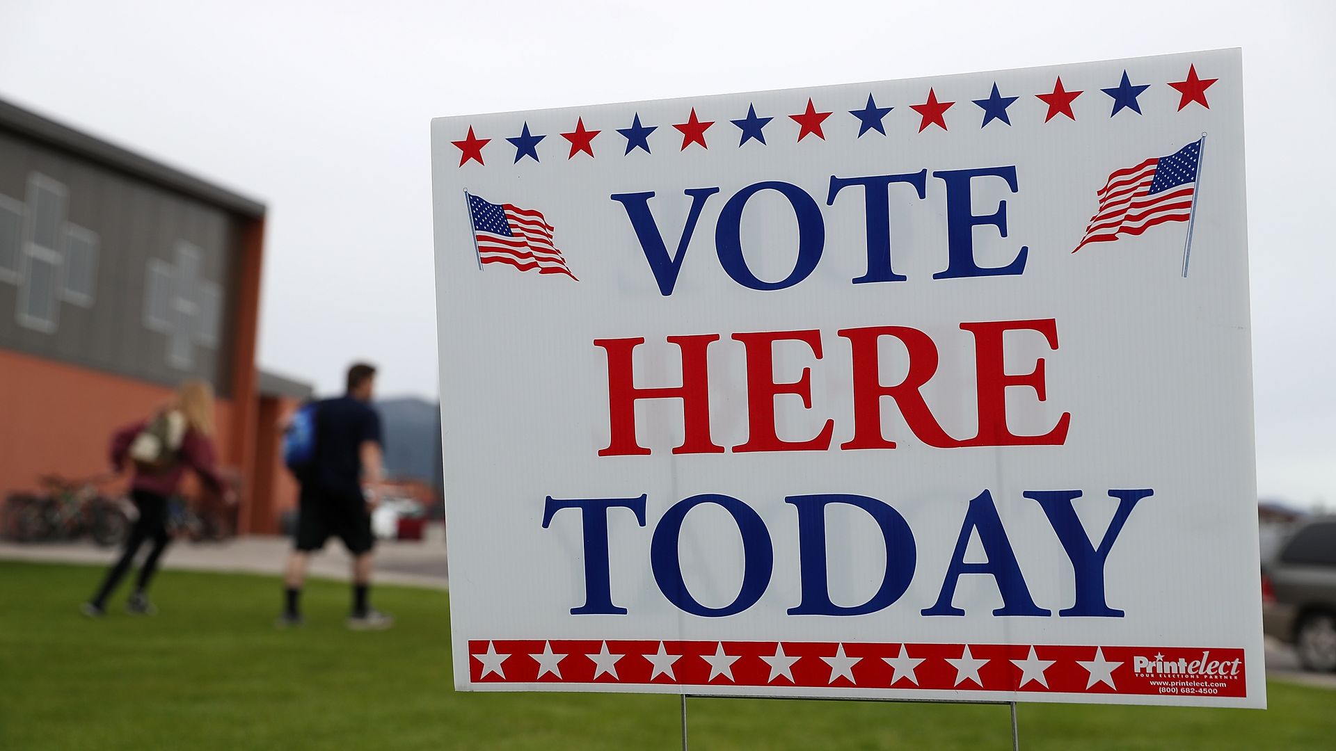 Sign in red, white, and blue that says "Vote here today" in all caps.