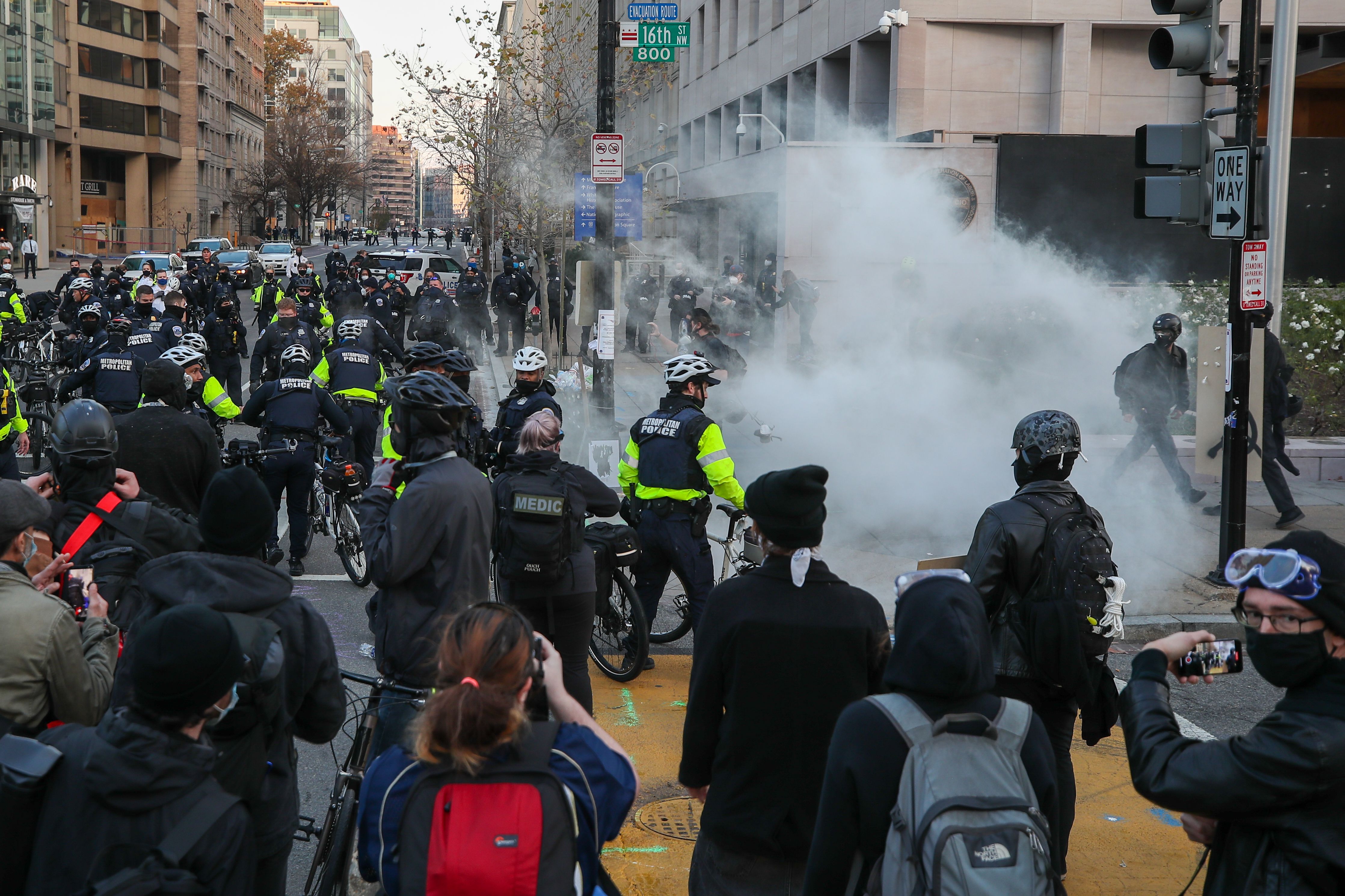 BLM protesters and Antifa clash with police as police officers intervene them with tear cas canisters at the BLM plaza in Washington, DC, United States on December 12