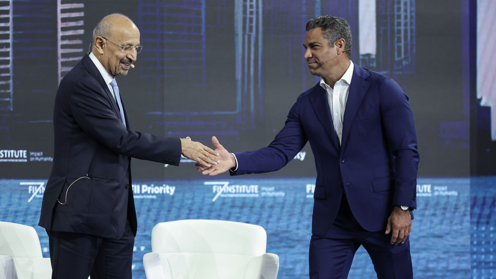 Miami Mayor Suarez shaking another man's hand. 