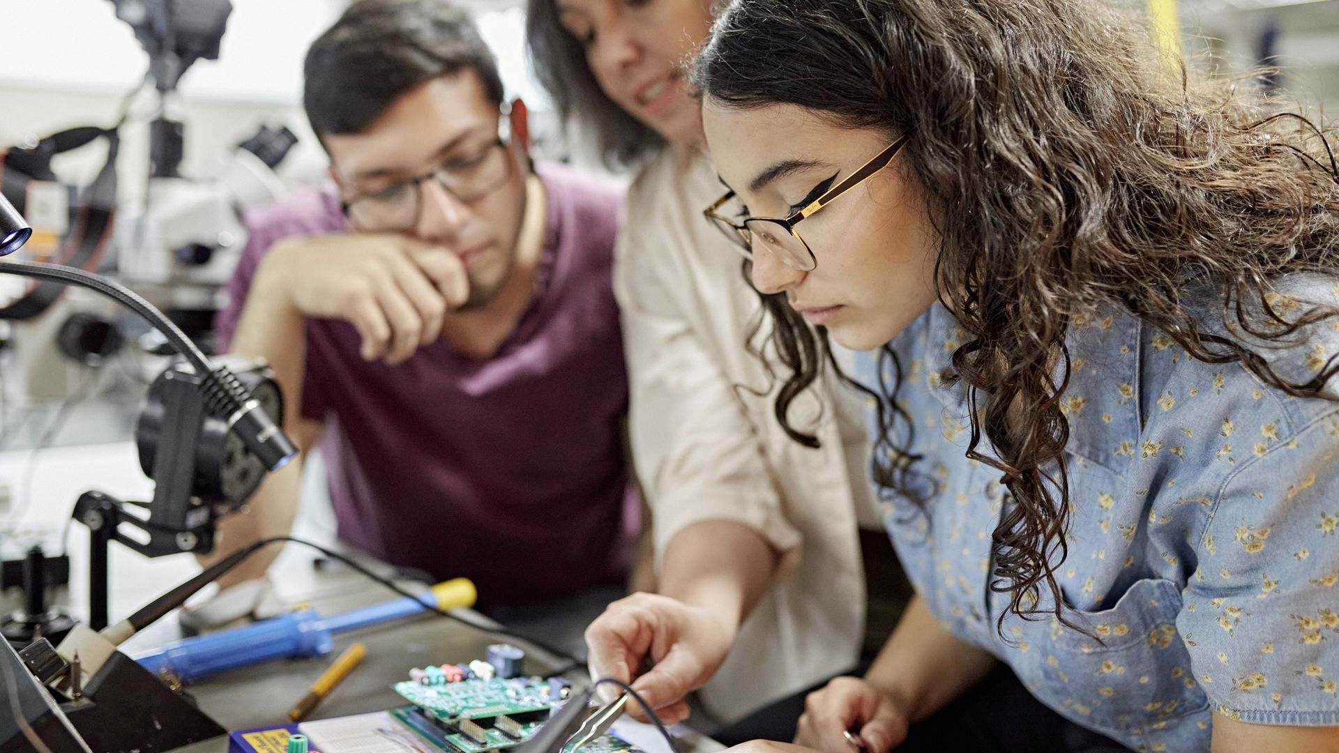 Two students learning technical skillsets. 