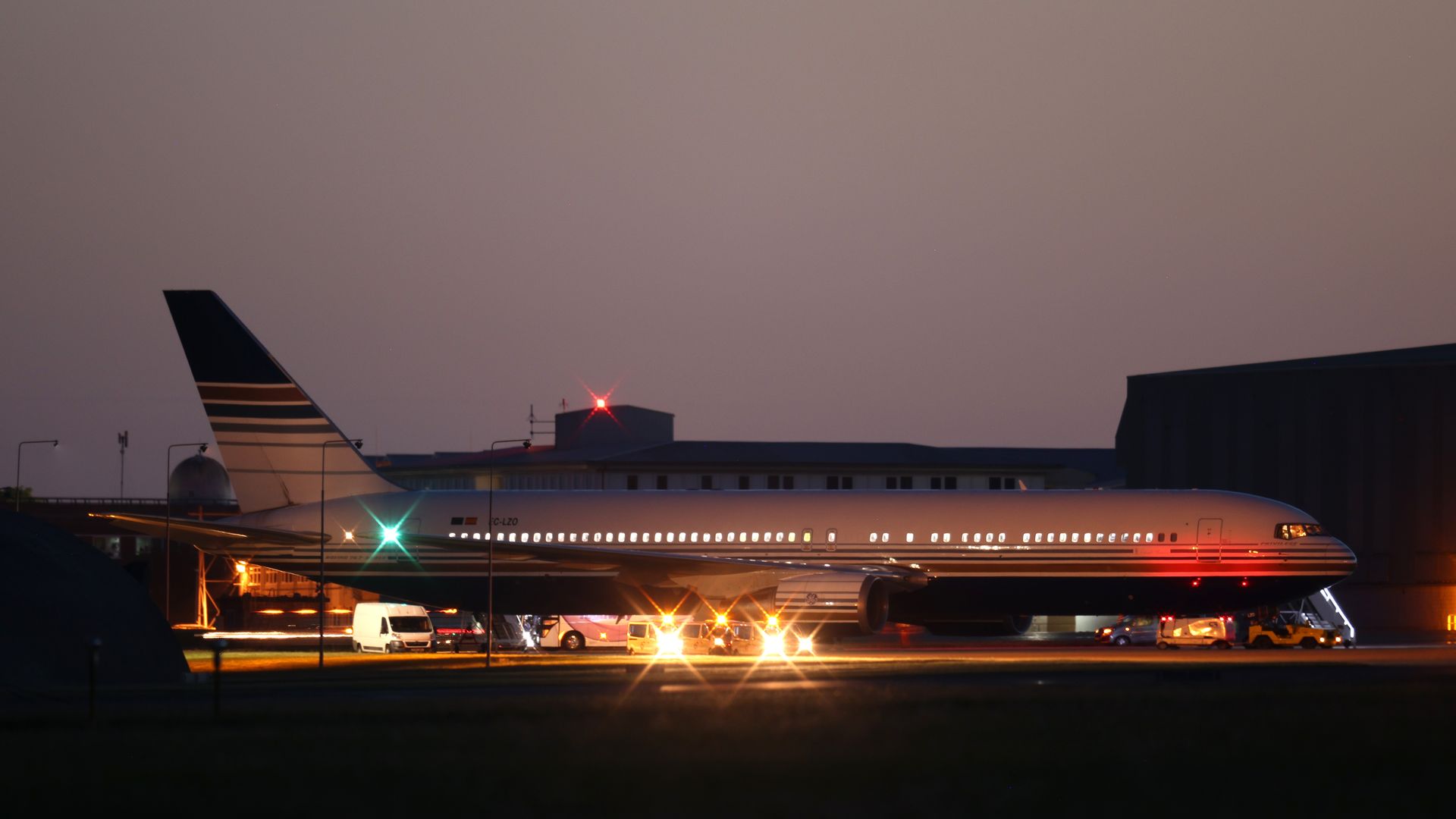 Photo of a grounded plane at an airport against the evening sky
