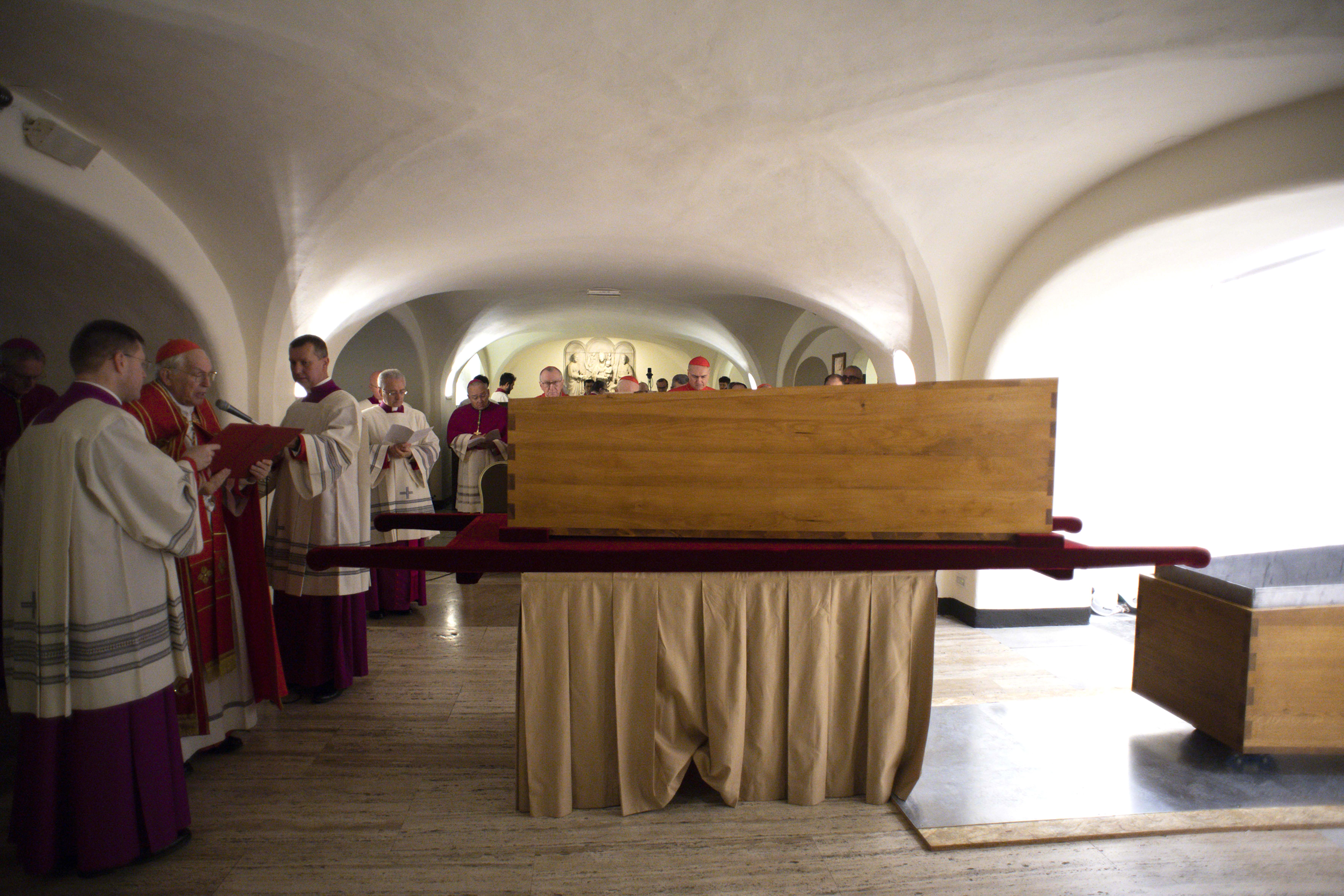 Cardinal Giovanni Battista Re (L) blesses the coffin of Pope Emeritus Benedict XVI.