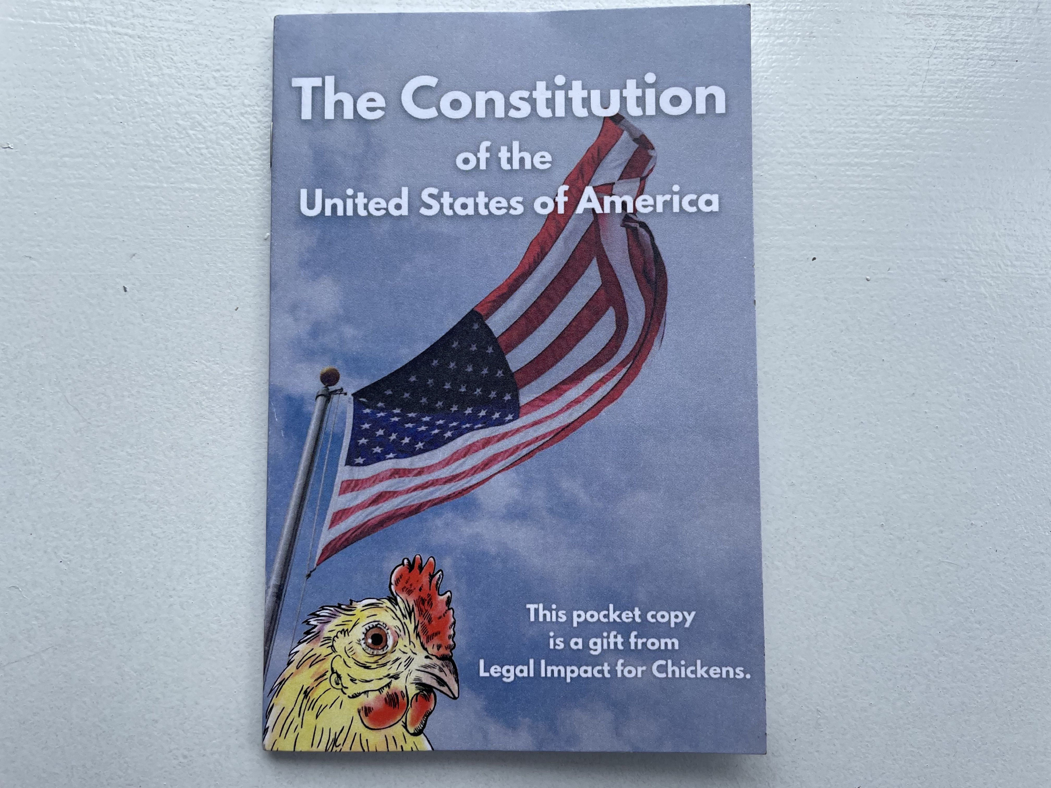 A copy of the U.S. Constitution with a drawing of a chicken on the cover.