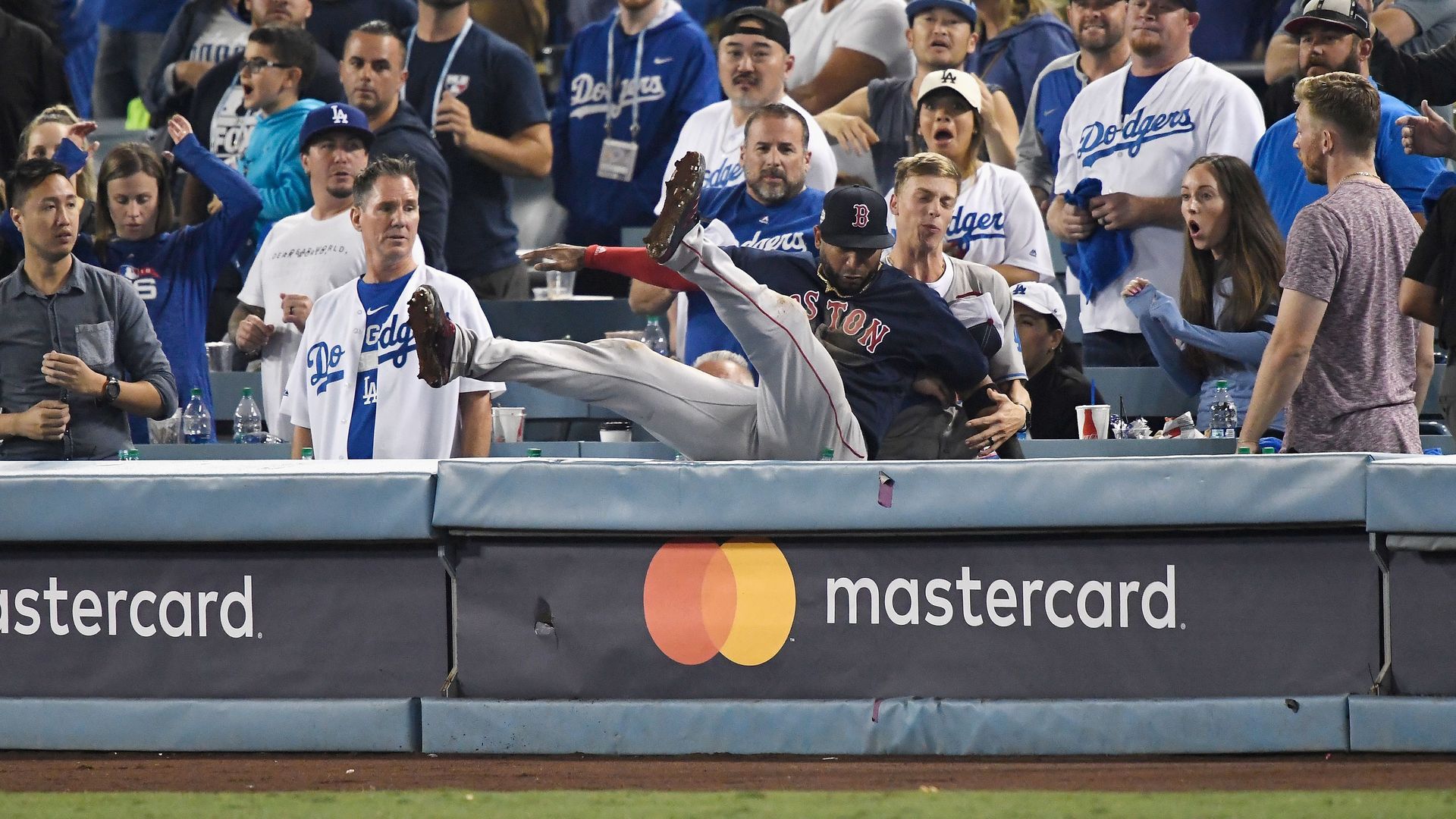 Boston mlb player falling backward into the stands.
