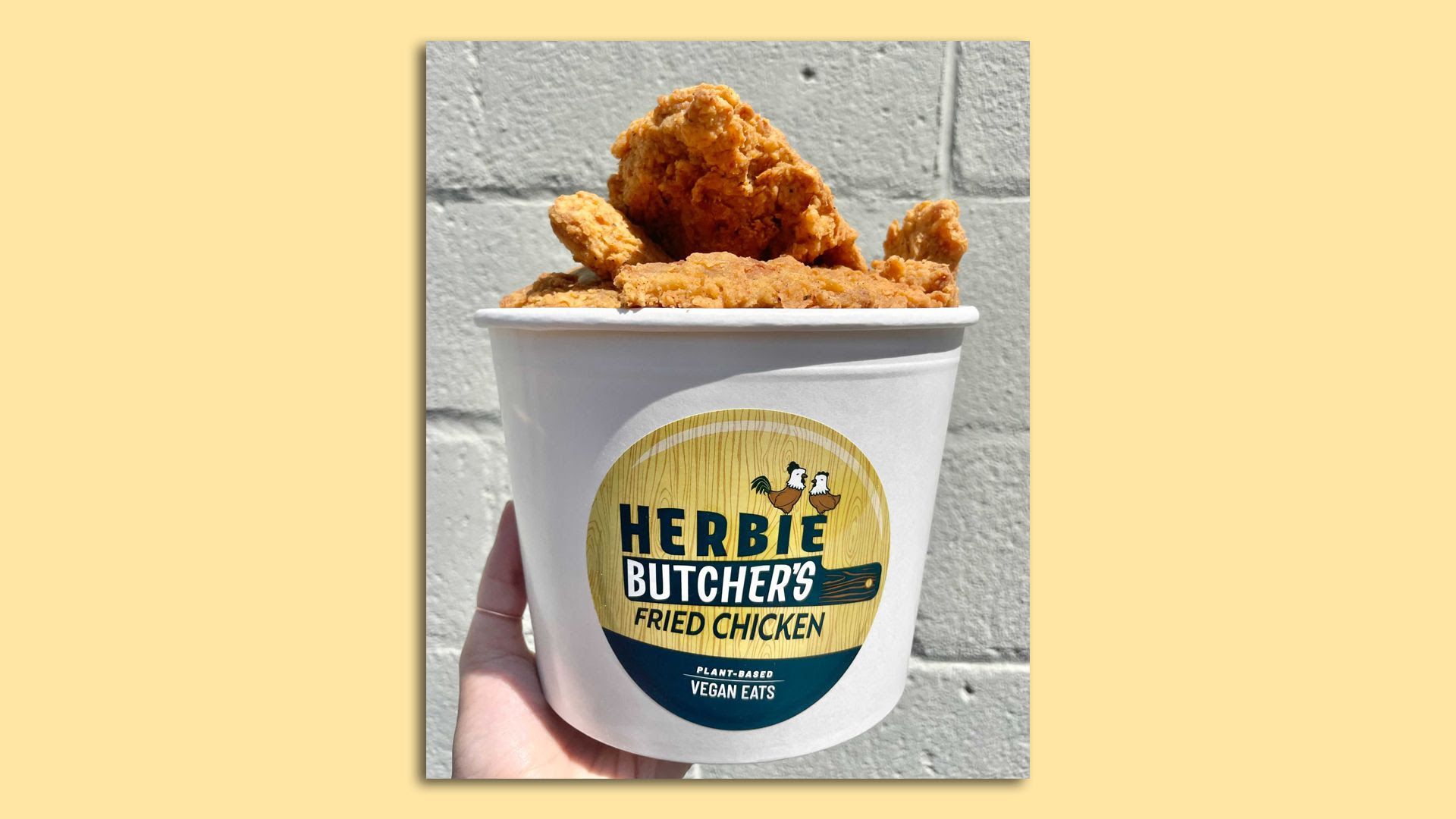 fried chicken in a bucket with a yellow sticker reading Herbie Butcher's fried chicken