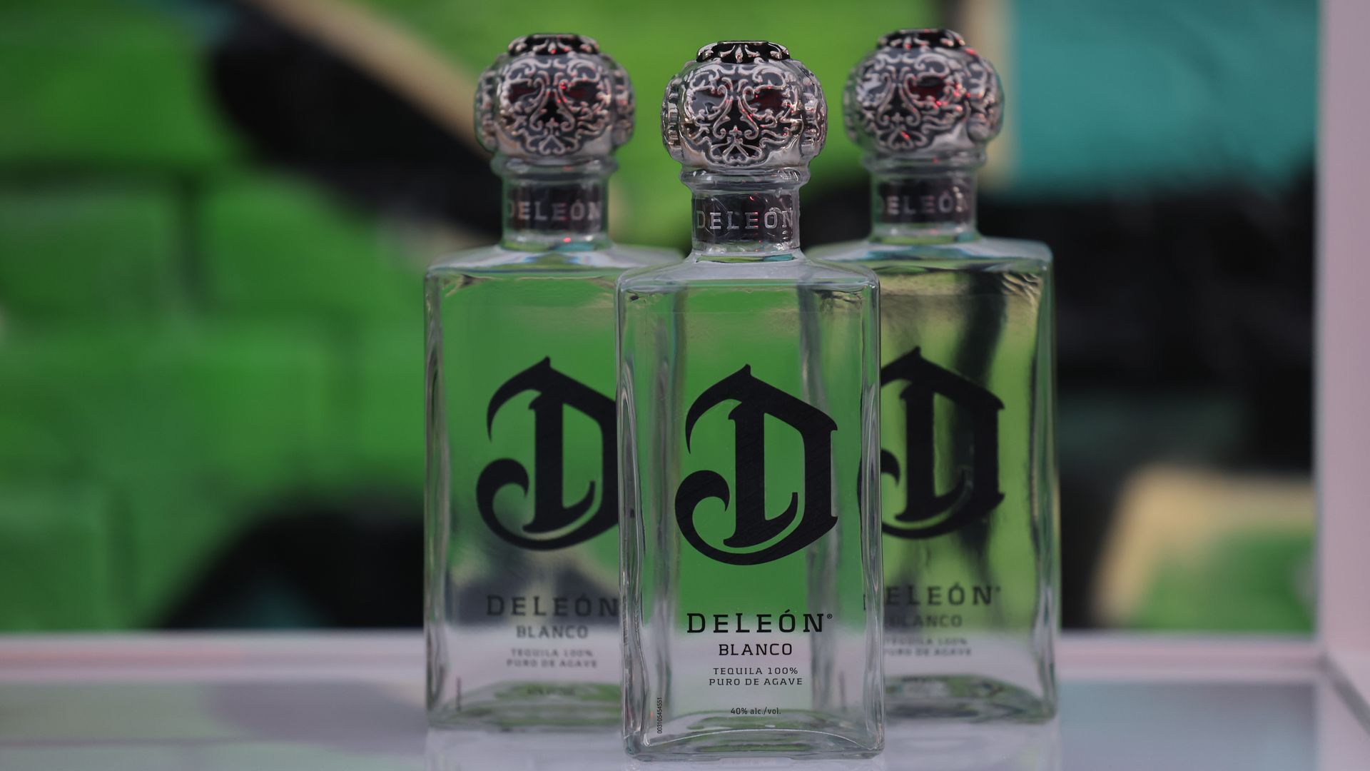 Three bottles of DeLeón Tequila on a table.