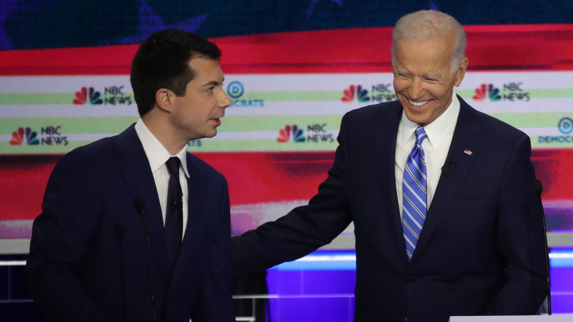 South Bend, Indiana Mayor Pete Buttigieg (L) and former Vice President Joe Biden talk during the second night of the first Democratic presidential debate on June 27, 2019 in Miami
