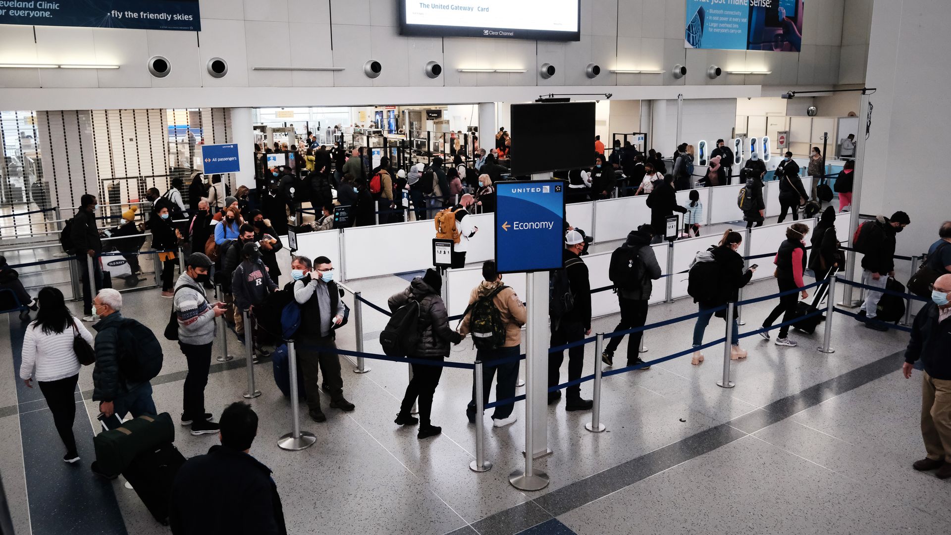 Travelers arrive for flights at Newark Liberty International Airport on November 30, 2021