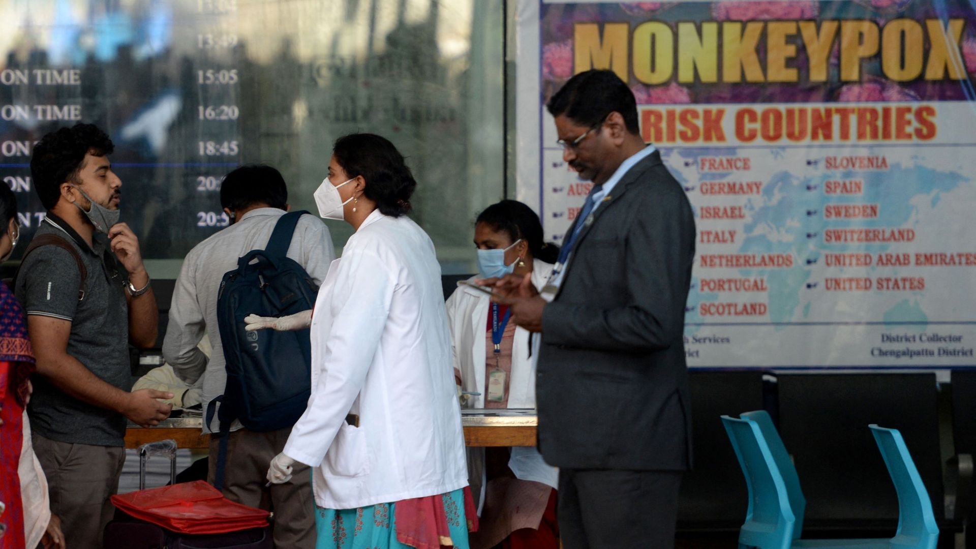 Health workers screen passengers arriving from abroad for Monkeypox symptoms at Anna International Airport.