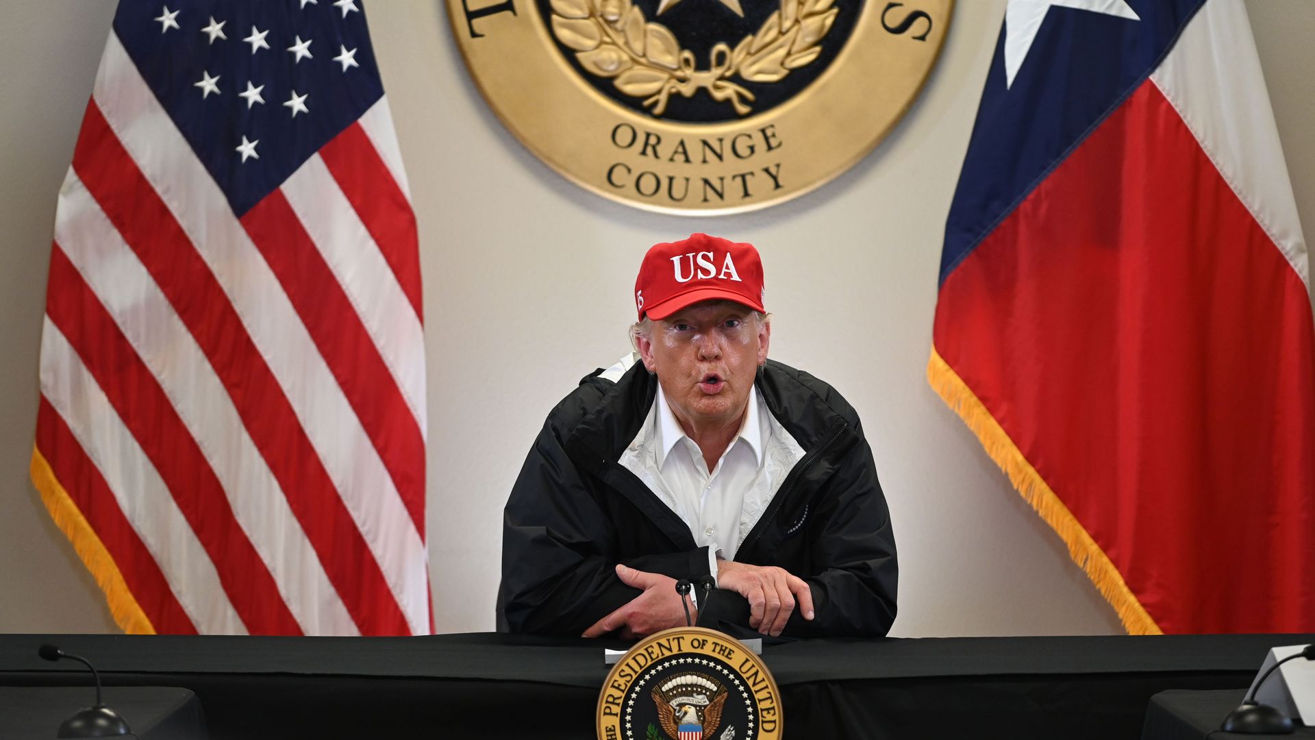 President  Trump attends a briefing at an emergency operation center in Orange, Texas, on August 29