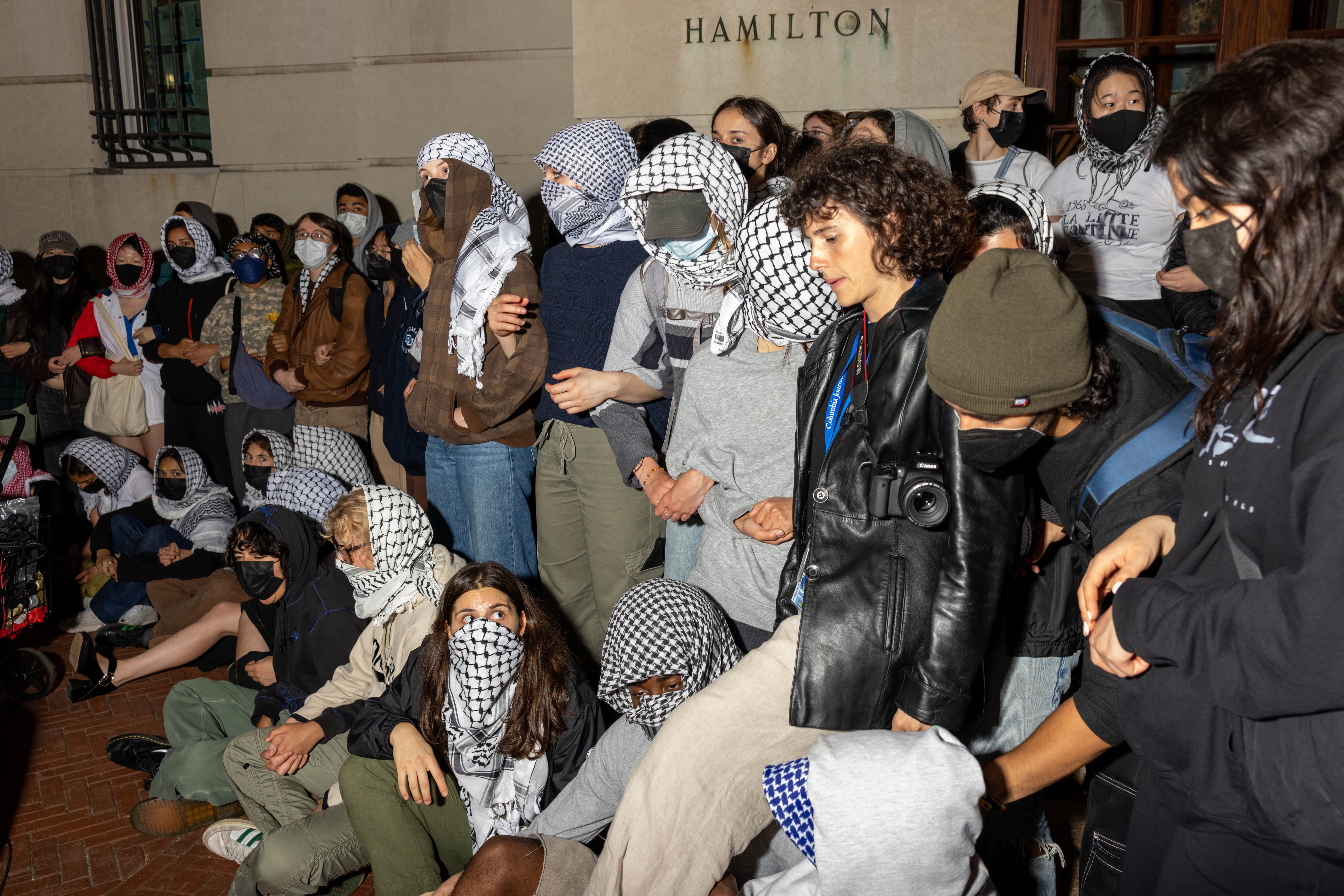 A group of pro-Palestinian protestors locks arms in front of Hamilton Hall. 