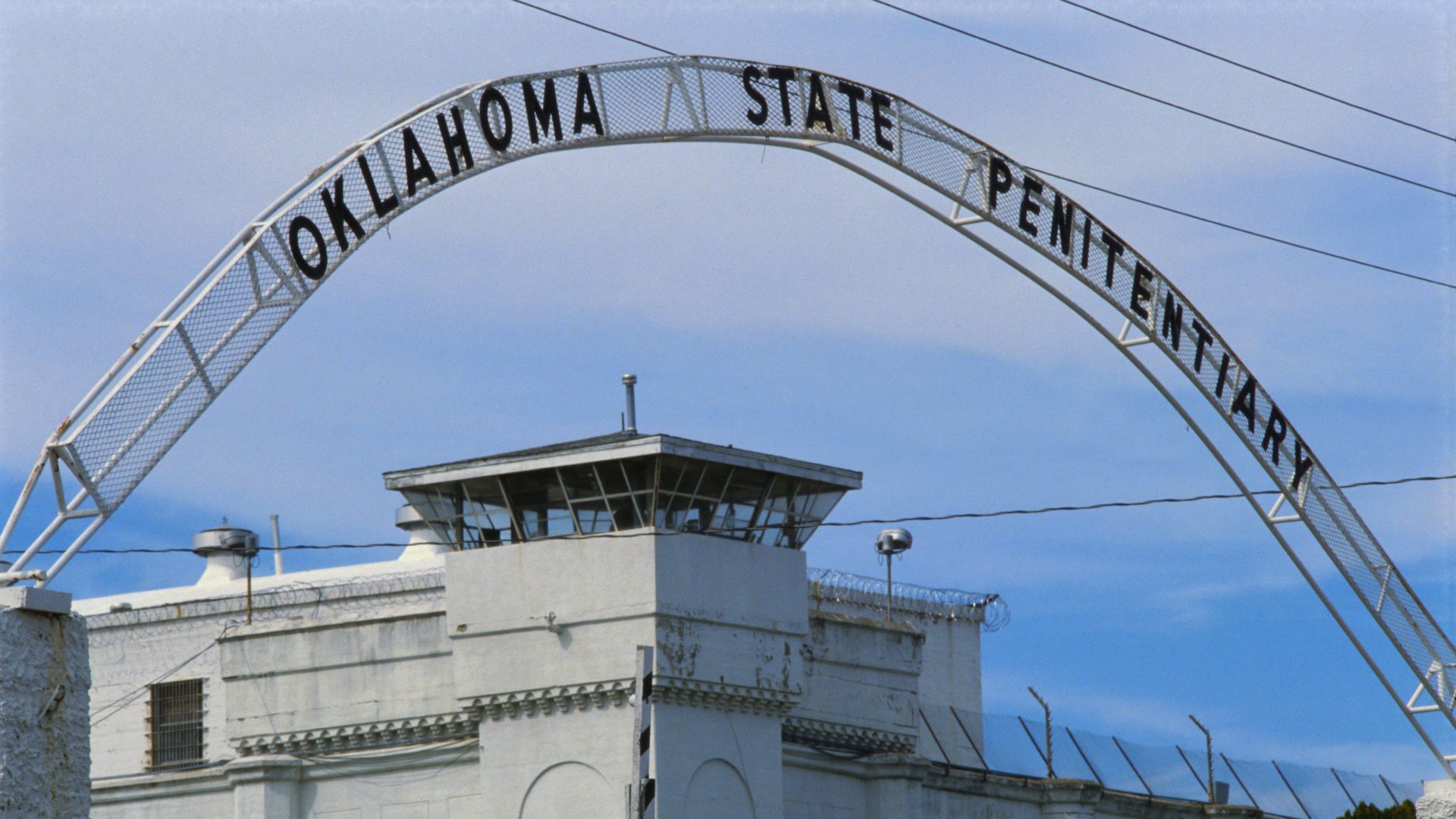 Picture of a prison with a sign that reads "Oklahoma State Penitentiary"