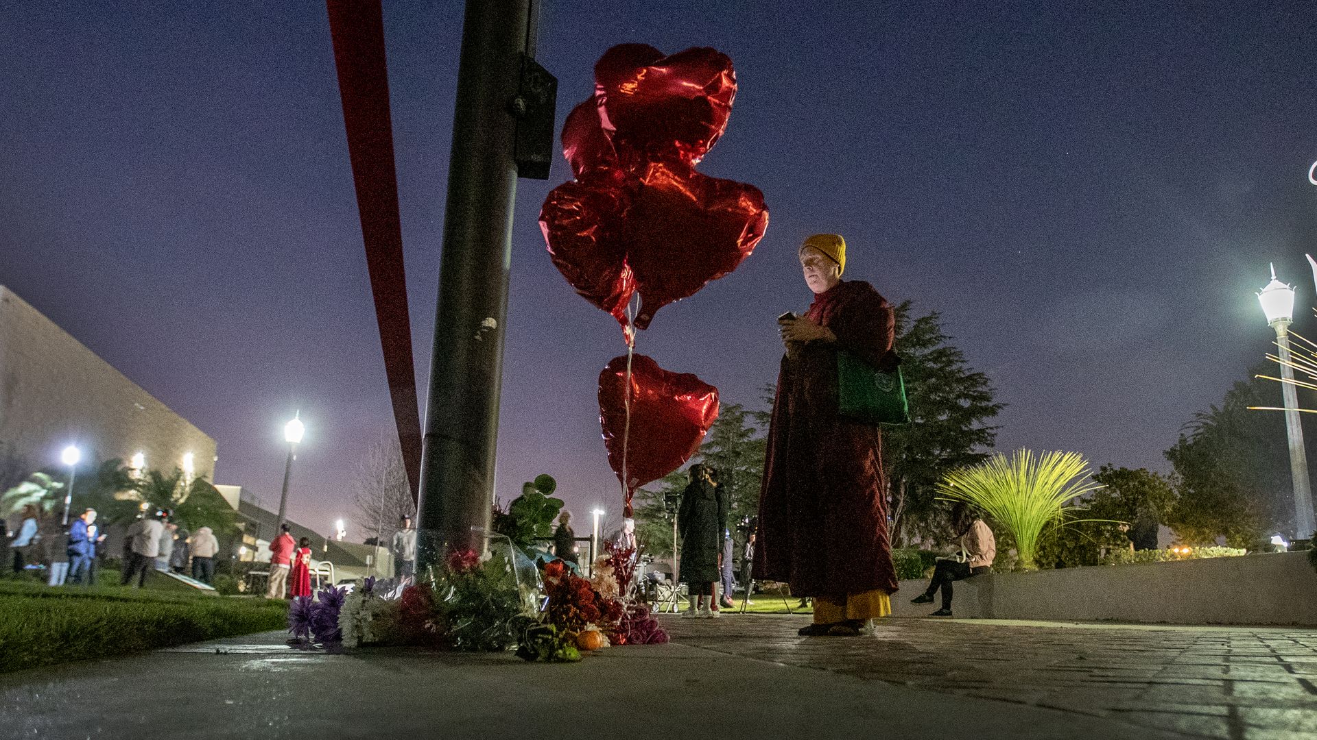  A person pays their respects at a memorial for Monterey Park mass shooting victims after a news conference at the Monterey Park Civic Center Sunday, Jan. 22.