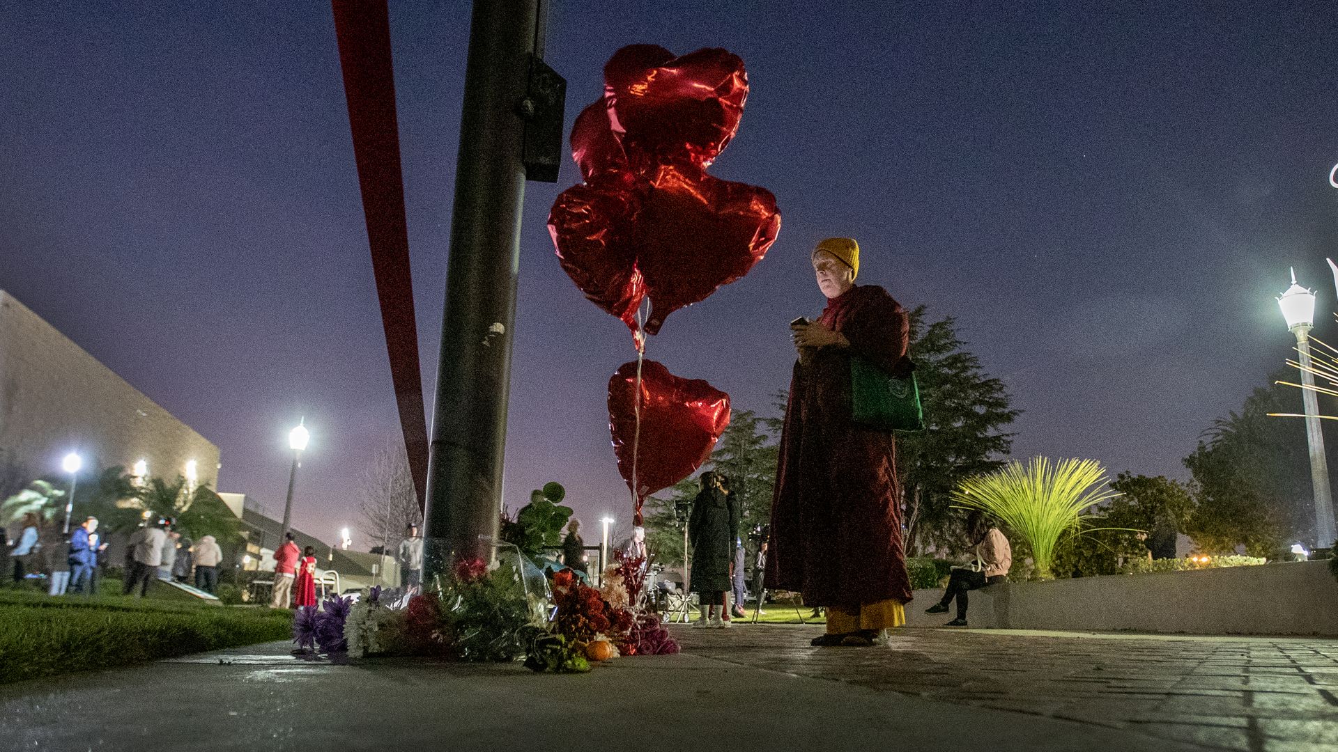 A person pays their respects at a memorial for Monterey Park mass shooting victims after a news conference at the Monterey Park Civic Center Sunday, Jan. 22.
