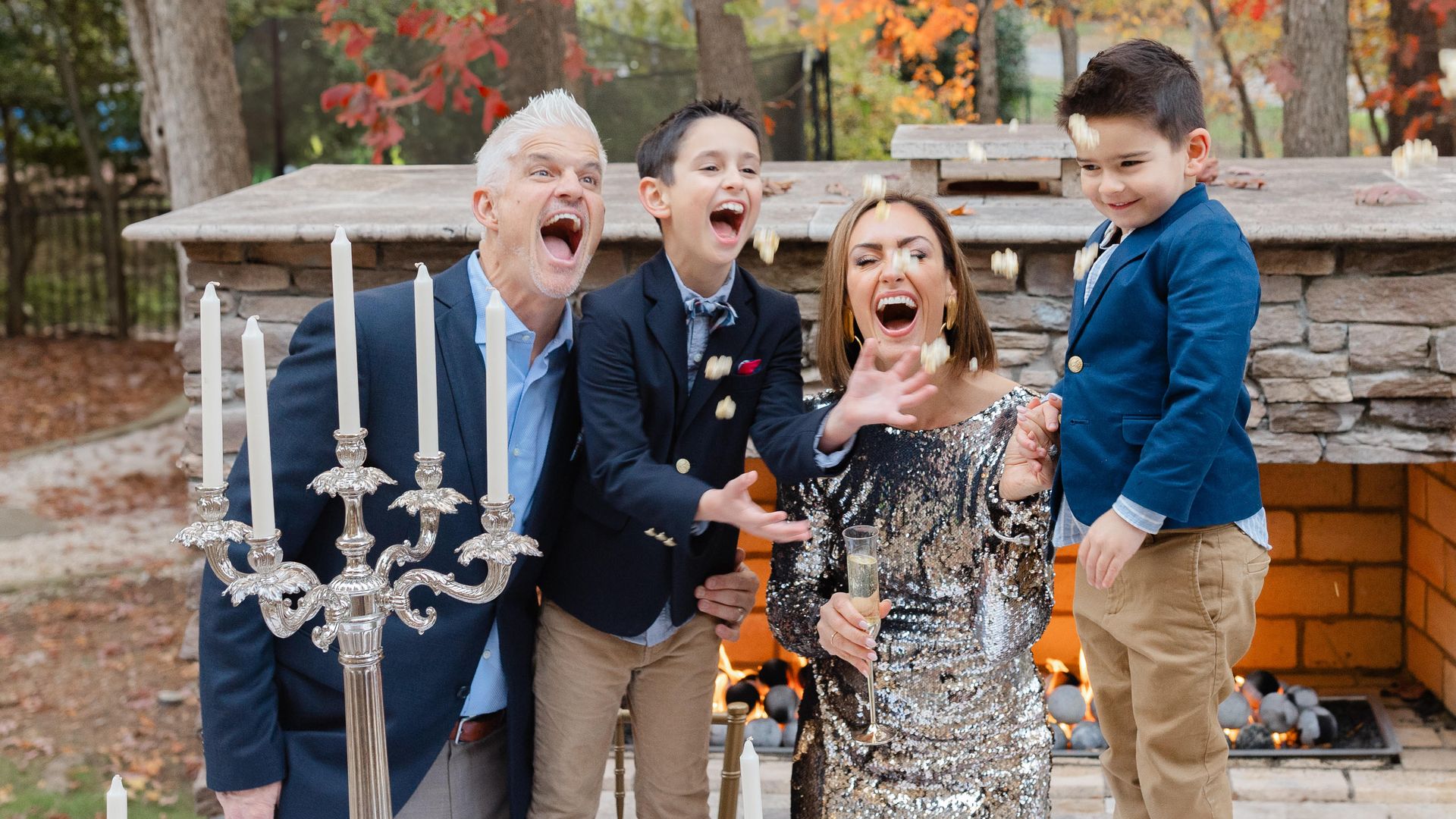 family throwing confetti up in the air