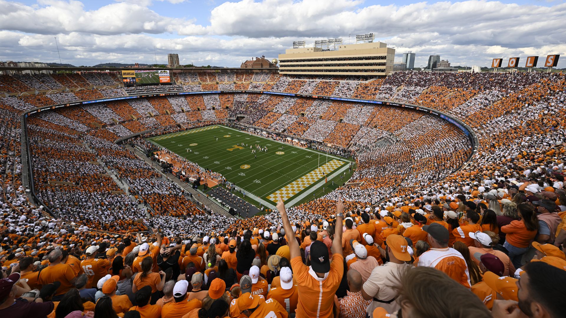 Tennessee Volunteers fans checkerboard the stadium in orange and white during a game.