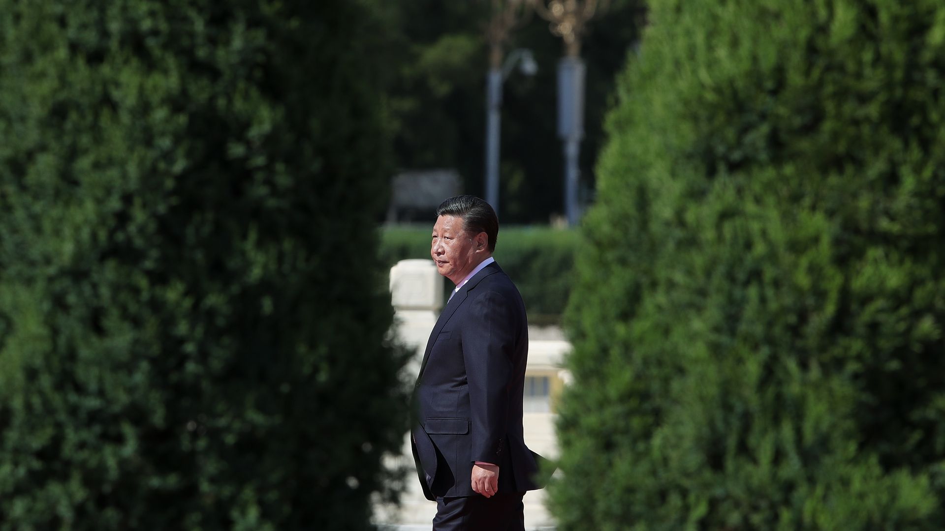 Photo of China President Xi Jinping walking on the grounds of a garden